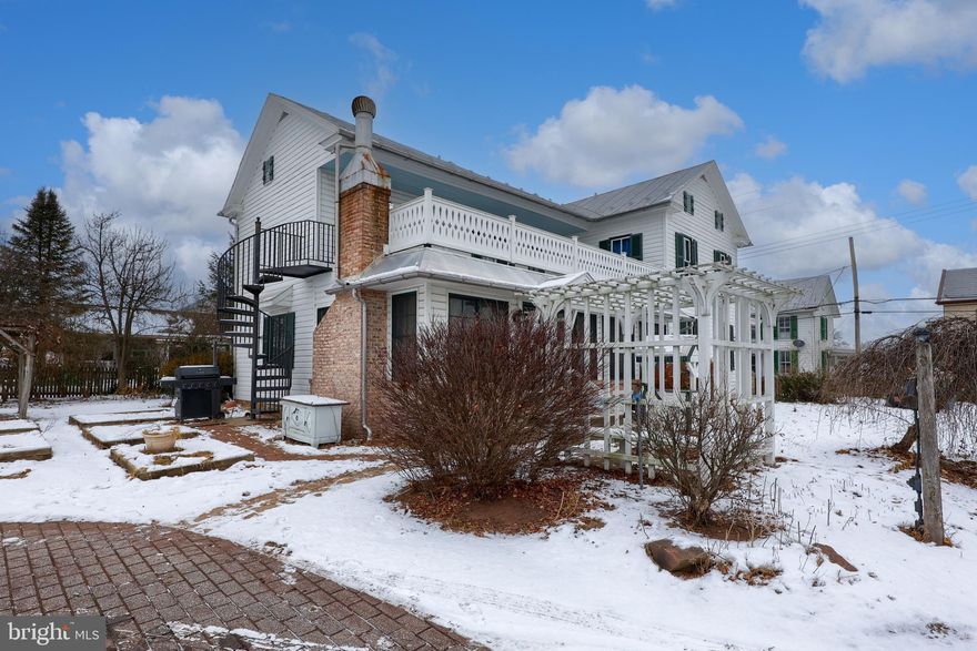Welcome to this unique and beautiful farmhouse that sits on 3/4 acres with the most breathtaking farm views in every direction you look!  This 4 bedroom, 3 1/2 bath home is filled with rich real hardwood flooring, hardwood steps and woodwork.  Previous owners renovated and started the floor plan to make a Bed and Breakfast. Therefore, each bedroom has an ensuite bathroom.  Outside, there is a working antique pump from the well encased by a little gazebo. Detached over sized 2 car garage,  and large barn or outbuilding that has a second floor, and a shed that currently hosts turkeys, chickens and a goat.  Boxed in gardens, exterior metal spiral steps from the balcony for fire escape safety or just added charm.  All brick free standing fireplace, great for entertaining! Home has sophisticated modern Septic system that is green, environmentally friendly, 1500 gallons of holding space, a peat moss filtration stage, and a high level tank alarm system. If you ever wanted the feel of living on a farm or the chance at a bed and breakfast, here it is. Schedule your showing starting 12/17/25 as this rare opportunity will go quick!