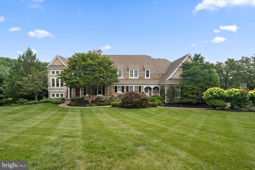 Unveil the gem that is the "Springhouse" – a home design masterfully executed by builder Chip Vaughn and architect Ann Capron. Set within a tranquil cul-de-sac amid the idyllic landscape of Chester County, the property showcases an alluring cedar shake exterior set off by beautiful landscaping.

The entrance invites you into a magnificent foyer characterized by 10-foot ceilings, bespoke moldings, and rich hardwood flooring that flows seamlessly across the main floor. The foyer branches off to a spacious living room, warmed by a fieldstone fireplace, and a well-appointed dining room replete with a butler's pantry, perfect for hosting dinners. The home also features a versatile music room, accessible via elegant French doors, leading out to one of the three spacious decks.

At the heart of the house lies the great room, boasting sophisticated coffered ceilings and a cozy fireplace, adjoining the kitchen. French doors open to a screened porch – a perfect vantage point to relish the beauty of the backyard sanctuary. The gourmet kitchen is a delight with its expansive 11 ft island, a custom-built sideboard, quality Kountry Kraft cabinets, and top-of-the-line appliances including a Miele double oven, steam oven, a Thermador cooktop, and a Sub-Zero refrigerator. The kitchen extends into a breakfast area featuring built-in cabinets and two beverage refrigerators, followed by a generously sized pantry with an additional refrigerator.

In addition to these features, a sizable laundry room offers a handy laundry chute and dumbwaiter, while a mudroom hosts built-in cubbies, a dog wash area, an additional powder room, and a compact office.

A grand staircase guides you to the second floor of the house, beginning with the luxurious master suite comprising a sitting area, two ample walk-in closets, and a spa-like bathroom boasting dual vanities with granite countertops, a large whirlpool tub, and a custom-tiled shower. Four other spacious bedrooms each come with their own en-suite bathrooms and walk-in closets.

The exquisitely finished lower level houses a kitchenette, family room with a built-in entertainment center, craft room, a gym that doubles as a movie room, and a spacious office. The outdoor retreat echoes a resort-like ambiance with an Armond pool and hot tub, all set within 3.25 acres of land that can be enjoyed from any of the three decks.
