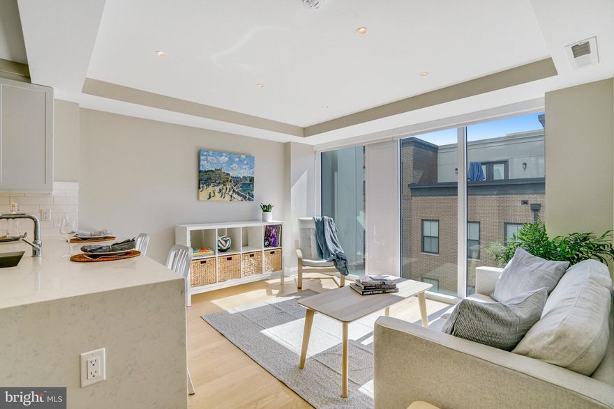 Welcome to your dream luxury 1 bed + den condo that lives like a  two bedroom.  This stunning residence features 875 square feet of thoughtfully designed living space, highlighted by a spacious den that offers ample room for an additional bed and a large closet for convenient storage.  This versatile flexible space serves perfectly as  a  productive home office,   a comfortable guest bedroom or art studio, adapting seamlessly to your lifestyle needs.

As you enter, you’ll be welcomed by gleaming wide plank light wooden floors,  an elegant open kitchen equipped with high-end appliances, quartz countertops and an eat in kitchen  that flow effortlessly into a light-filled living room, perfect for both relaxation and entertainment. The generous windows equipped with window treatments  invite abundant natural light, enhancing the modern design and creating an inviting atmosphere. The  oversized  primary bathroom has a double vanity and quartz  countertops.   One assigned garage parking space #80 is equipped with an EV charger (an additional $10k in value).  Unit is under builder warranty until December 6, 2025.

Enjoy an array of premium amenities, including a dedicated concierge service, a rooftop deck with panoramic river and city views with lounge areas and grills,  a modern styled party and meeting room, and a state-of-the-art fitness center, ensuring that every aspect of luxury living is at your fingertips. Experience the perfect blend of comfort and sophistication in this exceptional condo, where every detail has been meticulously designed to elevate your living experience. Don’t miss the opportunity to make this exquisite North Old Town property your new home steps from the Mt. Vernon Trail, minutes to Pentagon and Regan National Airport.