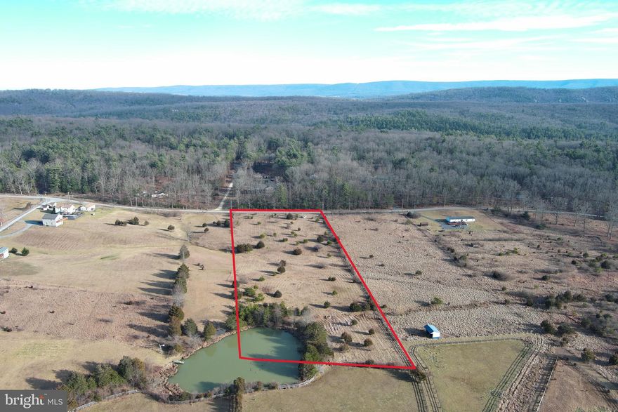 HOMESTEADER HAVEN......NEARLY 5 ACRES OF OPEN LAND WITH PAVED ROAD FRONTAGE, ONLY 25 MINUTES FROM WINCHESTER, VA! GREAT BUILDING SITES OFFERING FANTASTIC LONG RANGE VIEWS. PROPERTY CORNERS IN A 1/2 ACRE POND THAT'S SHARED WITH THE NEIGHBORS. THE PROPERTY ALSO OFFERS A GREAT POTENTIAL POND SITE WITHIN THE BOUNDS OF THE PROPERTY. MINIMAL RESTRICTIONS, NO HOA FEES, DOUBLEWIDES & MODULARS ALLOWED ON PERMANENT FOUNDATIONS. POWER & PERKED. GREAT FOR A TROPHY HOME OR MINI FARM, PLENTY OF ROOM FOR LIVESTOCK & GARDENING. IT'S SUPER HARD TO GET YOUR HANDS ON A PROPERTY IN THIS LOCATION THAT SUITS FOR A FARMETTE AND HAS PAVED ROAD FRONTAGE TO BOOT......RARE AS A HEN'S TOOTH!