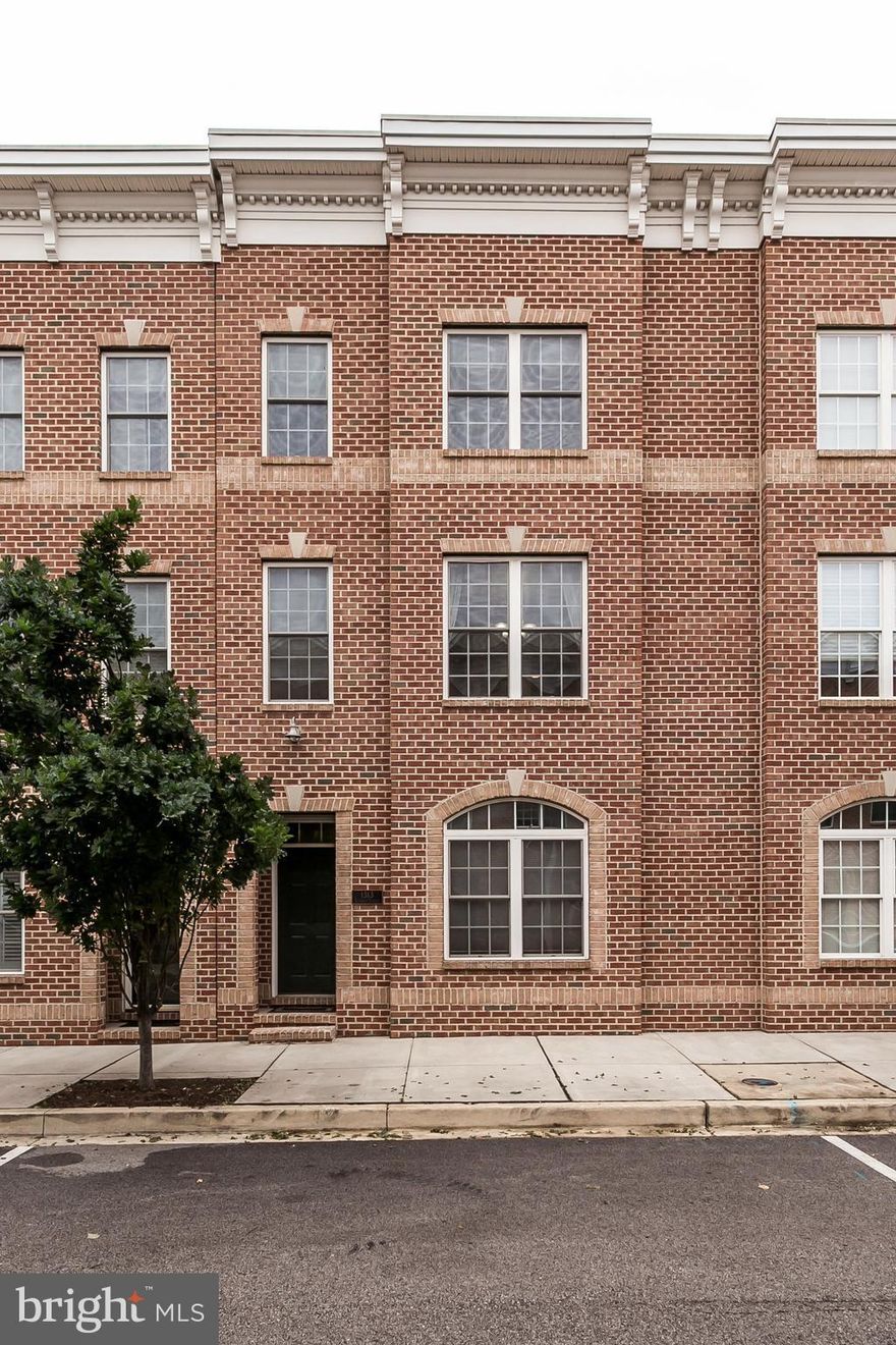 Spacious home in desirable Locust Point w/ parking, roof deck & hot tub! 1st level has entry hall, bedroom & rear door to 2-CAR GARAGE. 2nd floor is main living level w/ kitchen w/ granite & stainless, separate dining room, living room w/ fireplace. 3rd floor has 2 bedrooms & 2 full baths. Master w/ separate tub & shower, plus walk in closet. Interior stairs to roof deck w/ great views!