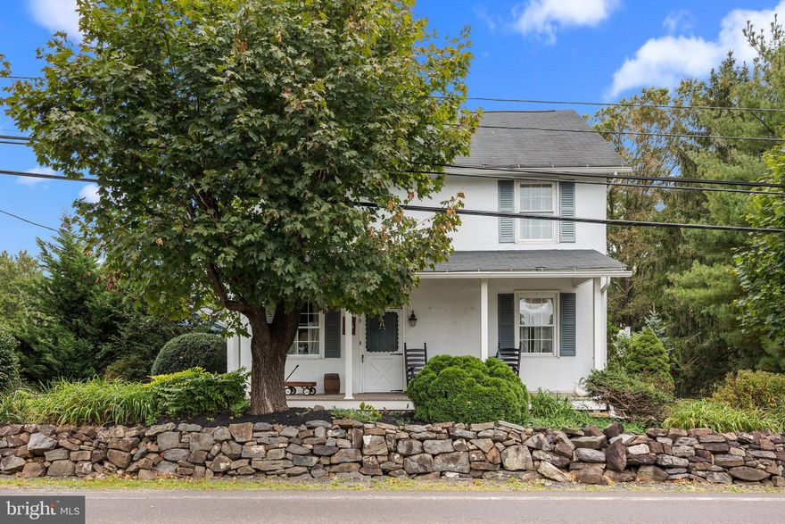 Welcome to 399 E Paletown Road, a charming 1870’s farmhouse that combines rustic appeal with modern comforts. As you step across the front porch into the inviting living room, you’ll admire the stunning brick fireplace with a wood-burning stove, newer flooring, and exposed wood beams. The adjoining dining room is the perfect setting for entertaining guests or hosting holiday gatherings. To the right, a cozy den or office space provides a quiet retreat for work or study. To the left, the country kitchen boasts solid hardwood cabinets, paired with ample counter space and updated appliances that make cooking and meal prep a breeze. The large sliding door offers a view of the sprawling deck outside, allowing for an easy transition to outdoor dining surrounded by nature. A laundry closet and a half bath conveniently round out the first floor. Upstairs, you'll find four generously sized bedrooms, each offering large closets and natural light. The primary suite, with its en-suite bathroom with a tile stall shower, provides privacy and comfort. The other three bedrooms share a full hall bath, complete with a tub shower. The curved wooden staircase leads up to the unfinished attic space, offering a blank canvas for your creative vision. Step outside to the enclosed back porch, a perfect space to unwind and enjoy the outdoors year-round, whether it's sipping morning coffee or enjoying the sunset. This lush 1.6-acre private lot boasts an above-ground pool, an expansive brick patio, manicured garden beds, and so much more. The detached four-car garage barn is a standout feature, offering so much more than just a place to park your vehicles. With two levels, there's ample storage space and a workshop area for DIY projects, hobbies, or crafts. Assigned to Quakertown Community School District, the home is just minutes from shopping, restaurants, parks, Lake Nockamixon, and commuter routes. This is an opportunity you don't want to miss. Call to schedule your private showing today!