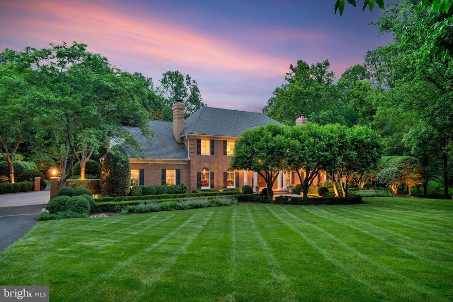 Refined Randolph Williams Estate on Nearly 3 Acres with Unparalleled Luxury Amenities

Crafted by renowned builder Randolph Williams, this exceptional estate sits on nearly three private acres and blends timeless architectural design with refined modern luxury. Thoughtful scale, exquisite craftsmanship, and hardwood flooring throughout define every room, offering elegant spaces for both grand entertaining and everyday living.

At the heart of the home, the gourmet kitchen is a true chef’s masterpiece, appointed with Wolf and Sub-Zero appliances, an ice maker, custom cabinetry, and generous workspace. State-of-the-art technology enhances comfort and convenience, including a Savant whole-house automation system, retractable entertainment screen and projector, zoned security and irrigation, and a whole-house generator. A 3-car side-load garage, abundant storage, and sun-filled interiors further elevate the home’s livability.

The residence offers a remarkable collection of luxury spaces: a richly appointed office with custom mahogany built-ins, a sun-drenched conservatory, formal living and dining rooms, a private exercise room, guest quarters, and a professionally designed wine cellar with temperature and humidity control. The stunning primary suite serves as a true retreat with cove lighting, a customized walk-in closet, dedicated washer/dryer, and a spa-inspired Carrara marble bath featuring a steam shower and soaking tub.

Designed by Charles Owens, the outdoor living experience rivals a resort. Multiple travertine patios, a screened-in mahogany porch, a pool and spa pavilion, gazebo, entry fountain, and a tranquil waterfall brook create an extraordinary setting for relaxation and entertaining—offering beauty and privacy in equal measure.

Superbly located just minutes from Tysons, downtown McLean, major commuter routes, and airports, this estate provides effortless access to Washington, D.C., while preserving a sense of complete seclusion.