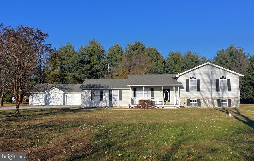 Need a garage workshop? This 3 car garage is insulated, has a separate heat pump, kitchen cabinets & sink, refrigerator & full bath!! Home was renovated in 2024-2025 with new luxury vinyl floors, fresh paint, new lighting fixtures, updated kitchen & baths, etc! Lower level reno underway for 2nd primary bedroom, bath, walk-in closet. Separate laundry room. 3 BR & 2 BA on upper level.  Deck for outdoor grilling or entertaining. Shed for your storage needs. Community pier just down the street for fishing or crabbing! This home should be ready for occupancy by Dec 19th or as soon as renovation is completed.