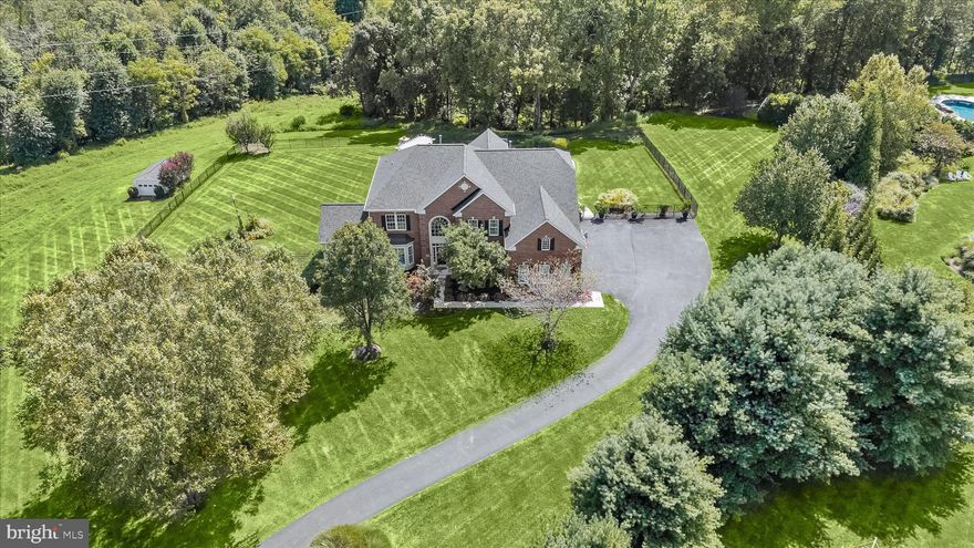 PRISTINE LUXURY ESTATE & ELEVATED RESORT-LIKE AMENITIES
Exceptional luxury estate offering nearly 8,000 finished square feet, ideally sited on a private cul-de-sac lot backing to a preserve parcel. This meticulously upgraded home showcases a seamless blend of elegance, comfort, and resort-style outdoor living.  Extensive recent upgrades provide peace of mind and modern appeal, including a new roof, HVAC, well system components, hot water heater, garage doors, major kitchen upgrades and bath renovations. The gourmet kitchen is beautifully updated with quartz countertops, a waterfall island, stainless steel appliances, gas cooktop, farmhouse sink, custom backsplash, and abundant cabinetry, flowing effortlessly into the breakfast area and sun-filled living spaces.

The main level features a grand two-story foyer with Brazilian mahogany floors and mosaic inlay, formal living and dining rooms with extensive trim work, a private study, and a stunning conservatory with walls of windows and heated floors. The spacious family room offers a gas fireplace with stone surround and opens to a bright sunroom with access to a low maintenance composite deck. There are two full-size sets of washers and dryers, along with a sink, counter space, and built-in cabinetry.

Upstairs, hardwood floors run throughout all bedrooms, including a luxurious primary suite with tray ceiling, sitting area, dual walk-in closets, and a fully renovated spa-like bath with heated floors, jetted air jacuzzi, and a spacious frameless glass shower. Secondary bedrooms are generously sized, featuring private ensuite or Jack and Jill baths. 

The fully finished walk-out lower level is designed for entertaining, complete with a recreation room, gas fireplace, custom wet bar with granite counters, game area, cigar/wine room with dedicated ventilation, sixth bedroom or fitness room with sauna, and a full bath with steam shower.

Outdoor living is truly exceptional, featuring a heated saltwater pool and spa, gas torches, pergola with stone fireplace, expansive composite deck with drainage system, gas firepit, porcelain paver patios, professional landscaping and mature trees.   Additional highlights include radiant heated tile floors, dual staircases, two gas fireplaces, upgraded lighting, a finished garage with built-ins, and extensive hardscape improvements.

A rare opportunity to own a thoughtfully upgraded, turnkey, executive home offering privacy, luxury, and exceptional indoor-outdoor living.