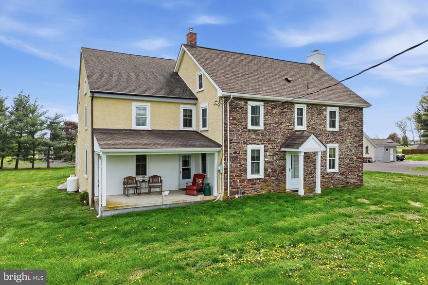 This circa 1756 stone farmhouse is rooted in tradition and is a salt of the earth authentic colonial era home that radiates quiet dignity and rustic simplicity. It's a historic home that has grown over time, blending original 1750s craftsmanship with later additions.
It was crafted from local indigenous materials, “such as roughhewn logs, native fieldstone and original wide plank floors. It's a timeless piece of colonial history that has weathered and evolved over 250 years.
It's situated on a 2.45-acre lot that is adjacent to a 48-acre farm field that yields corn or soybean crops annually. 
You will enter the home through a bright cheery sunroom. It’s a perfect place for your plants and the dogs or cats to lounge in the brilliant sunlight. It boasts of wide plank hardwood floors and skylight. Next is the spacious foyer with a convenient slate floor and convenient closets and shoe racks. 
Imagine yourself snuggling up in the warm and inviting family room on a cold winter night. This haven features exposed stone walls surrounding a wood burning fireplace. There are built in cabinets and bookshelves, wainscoting, wide plank hardwood floors and exposed hand-hewn beams. It will be the gathering place after a family dinner. 
The large country kitchen has been remodeled and features classic beaded inset cabinets, propane stove, microwave, granite counter tops, hardwood floors, deep country sink and stainless-steel appliances.  The adjoining breakfast nook is spacious and provides an ideal place for your informal meals or your morning cup of Joe.  Overhanging the granite counter tops is a timeless potholder for all of your pots and pans. 
Directly beyond the eat in kitchen is a formal dining room with exposed stone walls and sparkling hardwood floors. 
The remainder of the first floor has many possibilities according to your needs. There is a central room that currently serves as an office but could be a possible in-law suite or Au Pair suite. It has an adjoining second kitchen and a powder room. Directly off the second kitchen is a new composite deck for a possible barbeque or evening beverage retreat.
A newer addition to the home is a renovated space that currently serves as an office for the current owner.  It has many potential uses, and you can use it for your best purpose. The two rooms have high ceilings with very appealing architecture.  There is a new high efficiency heat pump for your cooling and heating. Some possible uses are a second family room, home office, in-law suite, game room, etc. Use your imagination. 
Retire to the second floor to find a large master bedroom area. It features hardwood floors, open beam ceilings and a remodeled bath. The bath includes a walk-in shower, soaking tub for your aching bones and his and her walk-in closets. The remainder of the second floor consists of four additional bedrooms, all of ample size and a remodeled hall bath with ceramic tile floors and glass shower. The third floor of the home features a fifth bedroom that is tucked away quietly. It would make a perfect teenage haven or guest room.
The entire home is warm and inviting. It's a perfect blend of old and new and has stood the test of time.
The possibilities are endless for the use of the three out-buildings. They include a three-car garage that measures 40x25 feet. It's a perfect place for a serious hobbyist or car collector. It has second floor storage as well as ample floor space. Additionally, there is a pole barn that currently serves as a storage area for the current owner’s business supplies. It's complete with a heated powder room and the possible uses are endless. 
The huge two-story bank barn measures 46x52 and needs some exterior siding repair but is generally in very solid condition. It has enormous possibilities and awaits your finishing touches. 
There are two smaller sheds as well for tool storage. At the rear of the lot is an old, paved tennis court. It's currently serving as a parking area for trailers.
