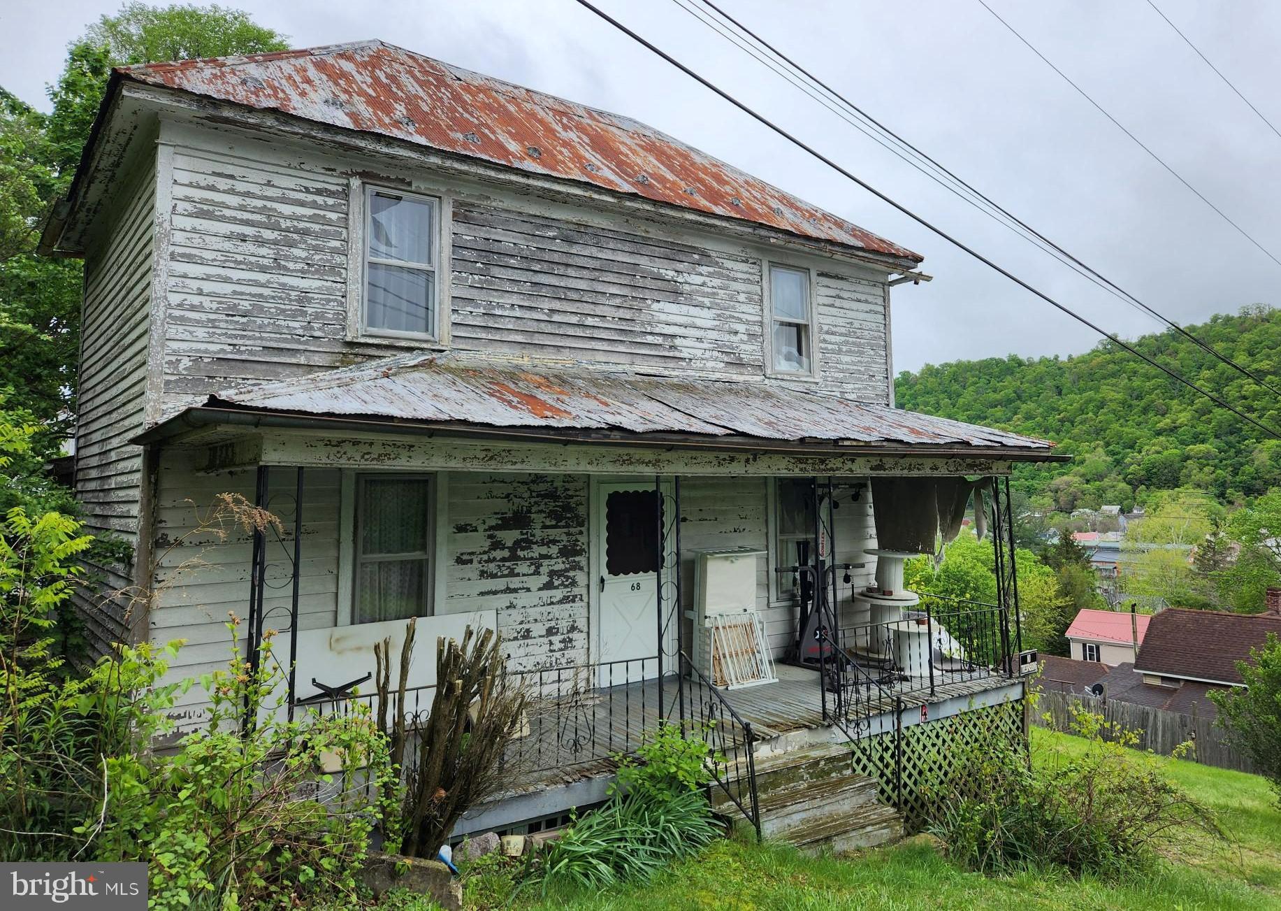 Fixer to fabulous! Discover the “olden days” in this 4 bedroom, one bath, circa 1920’s home on a large town lot. Lot is larger than most in town - has ample flatter areas to establish various parking options, and have a huge garden! Bring your creativity and restore all the natural wood while updating the rest of the space. Town amenities include the state park, movie theatre, Ice House Arts center, restaurants, shops - Travel across the mountain and you'll find access to the Cacapon River. Over the line in Maryland there's the C&O Canal bike path, rail trail and access to I-70 and points north and west. Cacapon State Park to the south with the lodge, cabins, restaurant, golfing, tennis, horseback riding, picnic areas, beach and lots of nature trails.