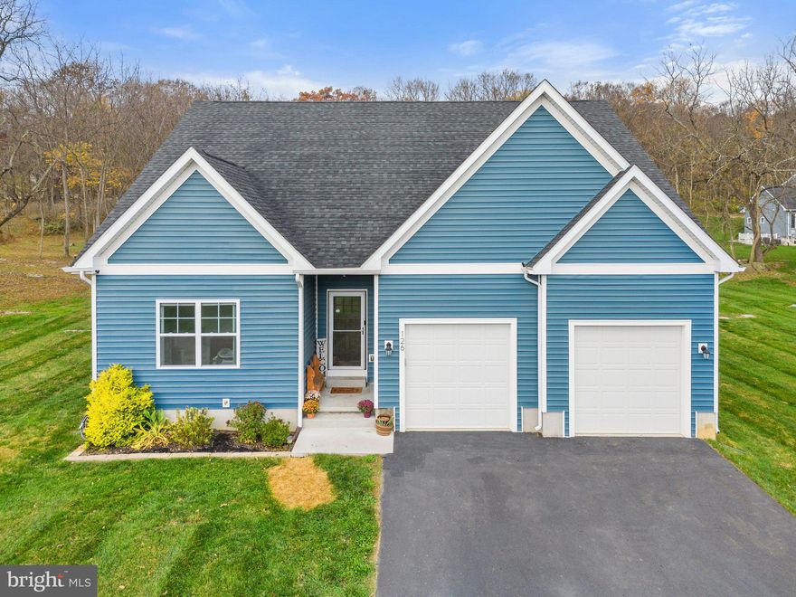 This charming property encompasses 5 acres of carefully planned landscape for your comfort and privacy, including an acre of densely wooded area at the rear. The heart of this home is its centralized kitchen and family room, with stunning cathedral ceilings and an inviting open floor plan. The family room exudes warmth with a corner stone gas fireplace, complete with a hewn log mantle and shiplap surround. The kitchen is equipped with granite counters, a walk-in pantry, deep farm sink, breakfast bar, and ample cabinet and countertop space, all conveniently connected to the breakfast room. The primary bedroom boasts tray ceiling and dual walk-in closets, leading to an impressive en suite bathroom with a rustic barn wood accent wall and modern lighting above the double-sink vanity. The beautifully tiled flooring guides you to the spacious walk-in shower. Both spare bedrooms offer generous dimensions, each with large closets and ceiling fans. Luxury vinyl and upgraded carpet throughout. Perfect for entertaining, the ample rear patio leads to an additional paver patio with outdoor wood burning fireplace.  Just a couple steps away is the perfectly placed playground with playset that conveys. This property was crafted with careful thought and consideration, which is evident upon arrival.