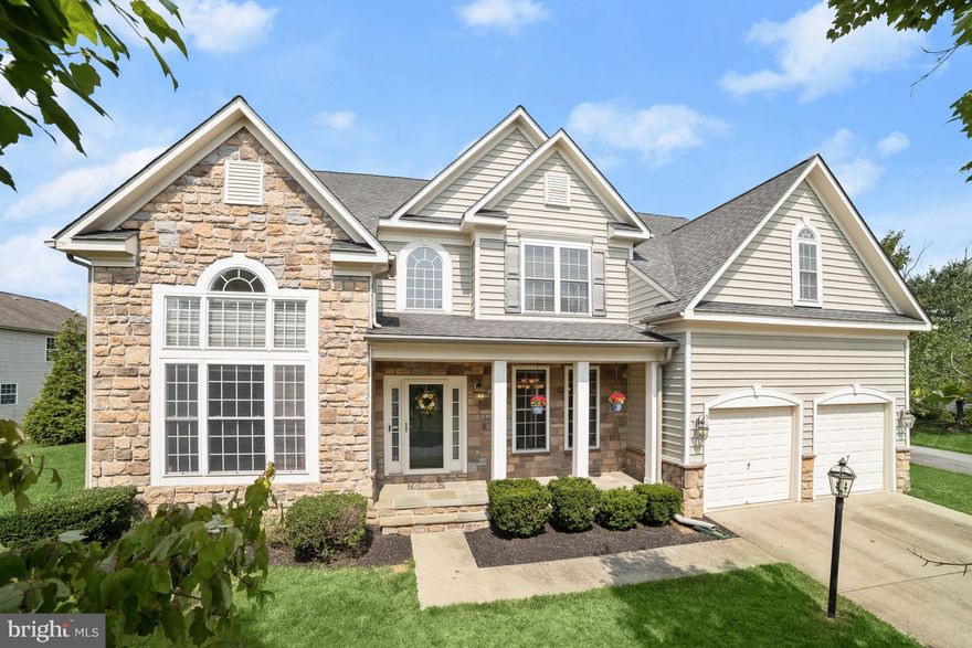 Beautiful, 2006 Max Award-winning Williamsburg Group home, located in the desired Glynchester Manor community of Ellicott City, boasts nearly 5,000 sq. ft. of luxurious living space with a bright and airy floor plan and updates that include the water heater, upper A/C, flooring, backsplash, French doors, countertops, invisible fence, and more!  Enter through the covered front porch to a sun filled, two-story foyer highlighting wide plank hardwood flooring and a soothing neutral color palette.  A high vaulted ceiling and accent molding are showcased in the formal living and dining rooms creating the perfect ambiance for intimate gatherings.  The kitchen features top of the line Zodiaq quartz countertops, a large island breakfast bar, 42 in. wood cabinetry, stainless appliances, and a breakfast room with deck access.  A rustic stone, gas burning fireplace creates the focal point of the off kitchen family room.  Through glass French doors is a home office with its own access to the deck.  Conveniently located on the entry level is the laundry room with built in cabinetry and a utility sink, and two half baths completing this level. Ascend the dual staircase to the primary suite detailed with two tray ceilings, and offers a sitting room with a cozy gas fireplace, walk-in closet and an en suite luxury bath with a jetted tub, separate shower, and dual vanity.  Completing this level are three additional bedrooms and two additional full baths.  The lower level has a bedroom, full bath, abundant storage space, and a recreation room with wide, walk-up stairs to the backyard.   Enjoy outdoor living on the expansive Trex deck on the landscaped yard backing to mature shade trees.