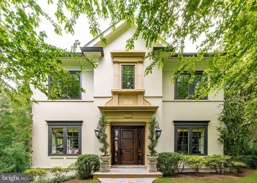 With just 46 distinguished residences nestled into the rolling hills, Phillips Park stands as Washington’s premier residential enclave along the esteemed Foxhall corridor. At its heart is 4414 W Street NW, a custom estate home artfully brought to life through the collaboration of Sandy Spring Builders, GTM Architects, and acclaimed designer Marlene Alexander , Three of the Capital Region’s most respected names in luxury homebuilding.

Set prominently along the street, the home is introduced by a meticulously landscaped lawn, thoughtfully designed by landscape architect Amy Mills. A flagstone walkway guides visitors to the stucco façade, adorned with Jeld-Wen windows and topped by a synthetic slate roof. At its center, a graceful cast stone pediment frames the solid cherry front door, offering a stately welcome.
 
Inside, a limestone foyer with a tray ceiling opens to views of a dramatic walnut and metal staircase, bathed in natural light from double-height landing windows. A formal powder room with an onyx sink, a walnut-paneled elevator, and a dignified coat closet are tucked into a side vestibule opposite the staircase. The traditional center hall layout places the formal living and dining rooms on either side of the foyer. The living room features a coffered feature wall and a Niermann Weeks chandelier, while the banquet-sized dining room is highlighted by twin Murano glass chandeliers.
 
A true butler’s pantry transitions into the chef’s kitchen, which boasts commercial-grade appliances, including a Viking six-burner range and KitchenAid refrigerator. Custom limestone backsplash, staggered tile flooring, and thick granite countertops with a waterfall edge elevate the space. An adjacent, light-filled breakfast room opens to the terrace for seamless indoor-outdoor living. Walnut floors continue into the expansive informal wing. The family room unfolds across two zones: one with a stone TV wall and beamed ceiling, and another with soaring cathedral ceilings and a fieldstone fireplace. Spanning over 32 feet in length, the space opens onto the full-width rear terrace through four sets of French doors, offering elegant flow for entertaining.
 
Upstairs, the primary suite is a serene retreat with ceilings soaring to over 16 feet, a limestone gas fireplace, a custom cherry headboard wall, and motorized blackout shades. A private home office, a fully built-out walk-in closet, and a luxurious limestone spa bath complete the suite. The bath is outfitted with heated floors, a steam rainfall shower, jetted tub, private water closet, and a three-inch-thick marble dual vanity. A dedicated dressing room, reminiscent of a high-end boutique, features a center island, glass cabinetry, custom seating, and gallery-style lighting.
 
Two additional upper-level bedrooms are generously proportioned, each with ensuite baths and walk-in closets. The lower level hosts a large, mirrored fitness room, two more bedrooms, a full bath, and an extensive mudroom and laundry area with direct access to the oversized three-car garage, which includes epoxy flooring and a custom workbench for the automotive enthusiast.
 
Advanced systems include Lutron lighting, Sonos sound, Ring and Crimpco security with video surveillance, central vacuum, redundant water heaters, copper plumbing, and fire suppression, ensuring the home is both luxurious and technically sophisticated.
 
Out back, the flagstone terrace offers sweeping views of the Washington Monument. A covered dining area, fire pit, grilling station, custom wrought iron lighting, and built-in speakers make it ideal for year-round entertaining. A full irrigation system and architectural landscape lighting maintain the grounds and cast a warm glow over the home after dusk.
 
Tastefully designed, impeccably constructed, and enviably located in one of the city’s most coveted boutique communities, 4414 W Street NW represents the very best in Washington luxury living.