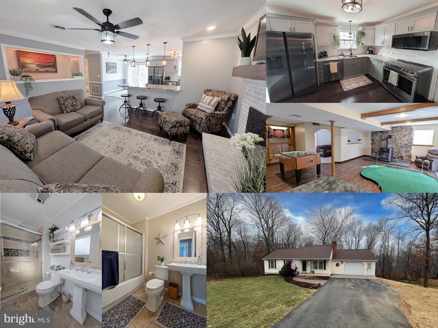 Discover the charm of this beautifully updated ranch-style home on nearly 1/2 an acre of land, with appx. 2,000 sq. ft. of inviting finished living space. The main level design centers around the open-concept kitchen with seated breakfast bar, allowing for easy interaction with the living and dining areas--perfect for both daily use and special occasion entertaining. The kitchen itself has been tastefully updated with slate stainless steel appliances, including a built-in microwave and dishwasher, rich wood cabinetry and granite countertops. Enjoy cozy evenings by the classic brick wood-burning fireplace in the living room, or head down to the finished walk-out lower level where a pellet-fueled woodstove with custom natural stone surround adds auxiliary heat if you ever need it. Featuring wood-look ceramic flooring, a separate den/lounge space, and wet bar, there is also a large bonus room in the lower level with double closet plus full bathroom across the hall giving incredible flexibility for use as a guest area, home office, or hobby area.  Back upstairs, the primary bedroom features an upgraded ensuite full bathroom , and a sliding glass door that opens onto the large deck, giving a wonderful open view of the woods. This special property adjoins public land, backing to the popular "Rails and Trails" recreation space, ensuring the tranquil view of mature trees will remain. The attached garage, with a single bay door but all the space of a two car garage footprint--has been upgraded with counters/cabinetry, workshop space, and an exterior door, plus a laundry room with utility tub. Ample driveway space can accommodate multiple vehicles, and the yard was recently terraced in the rear to give more level yard space for gardening or a future firepit area. Located near the vibrant Main Street area of Mount Airy,  you get the best of old and new, with nearby recreation opportunities, excellent schools, and easy access to public services, restaurants, and shopping. New roof (2025), new carpet, and a one year home warranty is available.