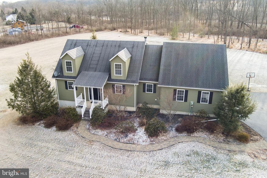 Gracefully set on 4.52 scenic acres within the Bellefonte School District, this charming custom‑built Cape Cod offers majestic mountain vistas & picturesque countryside views. Located less than 2 miles from I‑80 & I‑99 for an easy commute in any direction & just 7 miles from downtown Bellefonte, this property delivers the perfect blend of country living & everyday convenience.  Beautiful curb appeal & mature landscaping welcome you home. Inside, the open‑concept design provides an ideal layout for both daily living & entertaining. The spacious living room features a cozy corner wood‑burning fireplace & two sets of doors leading to the rear no‑maintenance deck with a retractable awning, the perfect spot to take in those incredible panoramic views. An additional deck features a built‑in fire pit, while the hot tub & above‑ground pool offer the perfect spot to unwind or cool off on warm summer days.  Back inside the well‑appointed kitchen boasts solid wood cabinetry, a darling breakfast bar & lovely pendant lighting, while a separate dining room offers the perfect setting for gatherings with family & friends.  A convenient main‑floor laundry/mudroom provides additional cabinetry, a utility sink & access to the oversized three‑bay garage with extra storage above. The first‑floor primary suite is a true retreat, complete with a walk‑in closet & a private full bath featuring a relaxing corner jacuzzi tub, dual vanity & walk‑in shower. Upstairs, you’ll find 2 nicely sized bedrooms, a bonus room & another full bathroom. The full unfinished basement offers ample storage or the potential for future finished living space.  Additional amenities include a main‑floor half bath, a heat pump with central air for year‑round comfort & a storage shed ideal for your garden tractor & tools.  A home like this invites you to slow down, breathe in the beauty around you & enjoy a lifestyle rooted in comfort, space & serenity, a truly special place to call home.  Seller shall be granted sixty (60) days from the date of offer acceptance to secure alternative housing, whether by rental or purchase. Accordingly, the settlement date shall be scheduled for a date no earlier than sixty (60) days following the offer acceptance date.