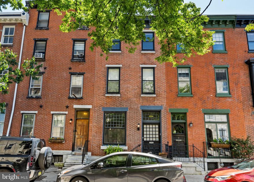 A beautifully reimagined townhome in Fitler Square that blends timeless character with bright, functional living spaces and the conveniences rarely found in city living.

Located at 2226 Locust Street, the home offers two-car tandem parking, exceptional natural light, and an ideal location just moments from Rittenhouse Square and 30th Street Station.

Period details including a dramatic oversized front window, original staircase, and gracious proportions are paired with an open main living level featuring hardwood floors, expansive living and dining spaces, an eat-in kitchen with commercial-grade stainless steel appliances, powder room, and direct access to the parking area.

The second floor offers a large family room with a corner fireplace and private deck, along with a bedroom, full bath, and laundry. Front and rear staircases provide convenient access throughout the home. Upstairs are two additional bedrooms and a beautifully finished bath.

The fully dug-out lower level functions as an ideal guest or in-law suite with its own kitchen and private entrance from the rear garden.

A rare opportunity for turnkey living in one of Philadelphia’s most sought-after neighborhoods.