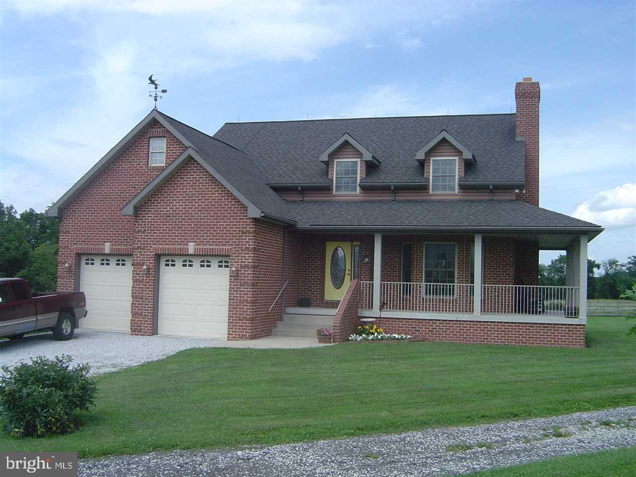 Beautiful custom built brick home set back on 11.8 acres. Vaulted ceilings, wrap-around porch & patio, 1st floor master suite, gorgeous red oak wood floors, 5 acres fenced for horses/livestock & 3 acres in hay, 32X32 barn, 6 car/equipment garage (32X50), full walk-out basement w/roughed in bath (see list for more improvements).
