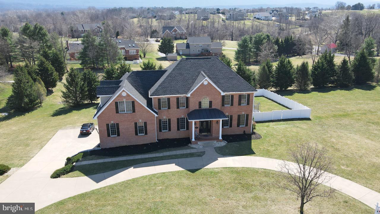 Stunning Colonial in Jefferson County's premier community of Eastland. This gorgeous property features 1+ acre of land, lush mature landscaping, mountain views, 6 Bedrooms including 2 Primary Owner Suites, 4.5 Baths, 5800+ Sq. Ft on 3 finished levels, Cherry Hardwood flooring, and Upgraded trim and moldings! Main level has a two story Foyer, Formal Living and Dining Rooms, Gourmet Kitchen with granite counter tops, Stainless appliances including the double wall oven, island with cooktop, Maple cabinetry, and breakfast room for dining, the first of two Primary Owner Suites with attached Full Bath, and laundry. Upper level has 5 additional Bedrooms including the second Primary Owner's Suite with attached luxury bath and a Princess Suite with attached full bath. 3 additional Junior Bedrooms share the 3rd Bath. Lower Level has a large recreation room and walks out to the rear fenced yard with deck above for outdoor entertainment! 2 car side load garage. Eastland Community features 100 Custom Homesites with walking trails, private lake and picnic area, and is conveniently located off Rt 340 for easy commuter travel! *Roof and gutters replaced in 2018* *Septic Pumped in 2022* Truly a MUST SEE!!