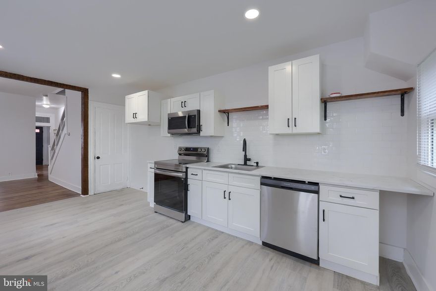 Welcome to this charming home, featuring arched doorways on the main floor. A spacious main floor includes living, dining and kitchen spaces with hardwood floors. Newly appointed kitchen with new cabinets, granite countertop, appliances. 2nd floor houses 3b/1ba and hardwood floors. 3rd floor is a bonus area, offering more living space in this city home. Natural gas radiator heat. A postage size back yard, waiting for some creativity.