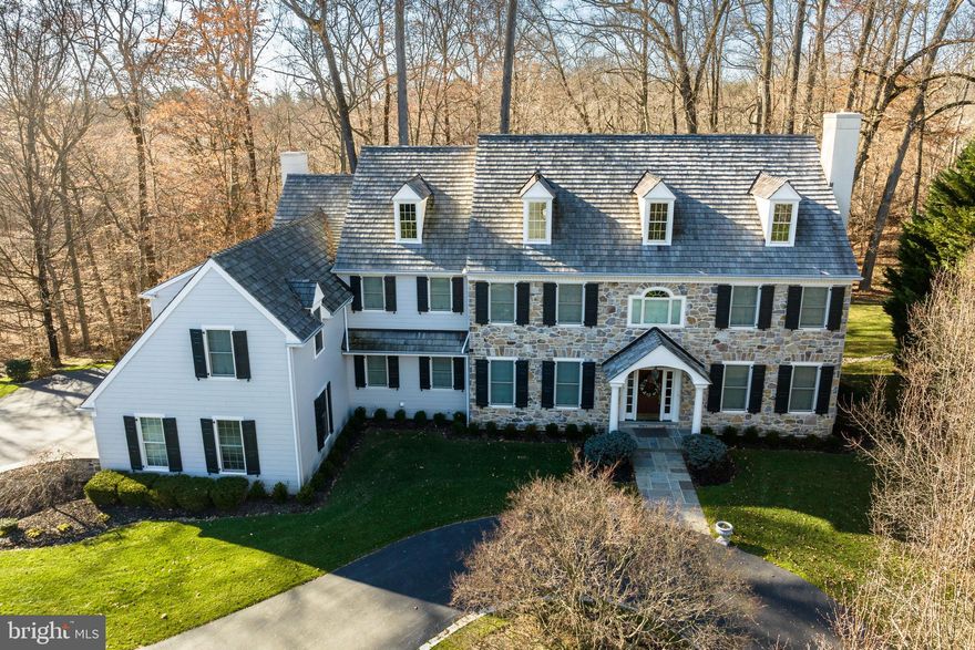 Welcome to 145 Brooke Farm Rd.! This stunning home offers a unique combination of luxury and convenience in highly sought-after Radnor Township. Boasting an impressive facade and lush landscaping, this home sits on a private lot at the end of a quiet cul-de-sac. Stepping inside, you'll immediately notice the attractive hardwood floors and crown molding that flow throughout most of the main level. To the right is the formal sitting room with a fireplace and natural light pouring through the large windows. Flow from the sitting room into the office featuring gorgeous built-in cabinets and shelves. Looping back around to the main entry, you will find the spacious dining room that is perfect for all your gatherings. A convenient wet bar is perfectly situated off the dining room and kitchen, ready to serve you and your guests in either space. The kitchen is perfect for entertaining thanks to the large island with granite countertop and built-in gas stove as well as open eyesight into the living room. Modern white cabinets and the walk-in pantry provide tons of storage space for all of your kitchen essentials. Enjoy the incredible panoramic views of the wooded backyard from the breakfast room off the kitchen with access to the back deck. Step down from the kitchen into the cozy living room with fireplace and large windows providing views of the quiet creek that runs behind the house. Two half baths and laundry room complete the main level. Choose one of the two staircases to head upstairs to the expansive second level. Relish the privacy of the incredible primary bedroom suite featuring a spacious sitting room, generous bedroom with tray ceiling, two walk-in closets, and an en-suite bath with his and hers sinks as well as a jacuzzi tub. Down the hall, you will find two large bedrooms joined by a shared bathroom. Two more generous bedrooms with attached full baths complete the upper level. There is so much more to see as you head down into the partially finished basement with walk-out access to the serene backyard. The game room flows into the media room with plenty of space to entertain all your family and friends. Another bedroom and full bath offer a private space for your guests to stay. Two large, unfinished areas of the basement offer storage or flex space that you can finish to suit your needs.  In addition, the basement has private garage access. Outside, enjoy a quiet cup of coffee in the mornings or fire up the grill on the back deck. There is plenty of parking for you and your guests thanks to the three car garage and stately circular driveway. Recent updates include all new exterior siding, stone, doors, and windows. That's almost half a million dollars in exterior updates! The roof was also replaced in 2015. This home sits just minutes from all of the incredible restaurants and shops that Wayne has to offer. Golf lovers will enjoy the short, 5 minute drive to Aronimink Golf Club and 15 minute drive to Merion Golf Club. With its prime location and exceptional amenities, this home truly has it all! Schedule your tour today!