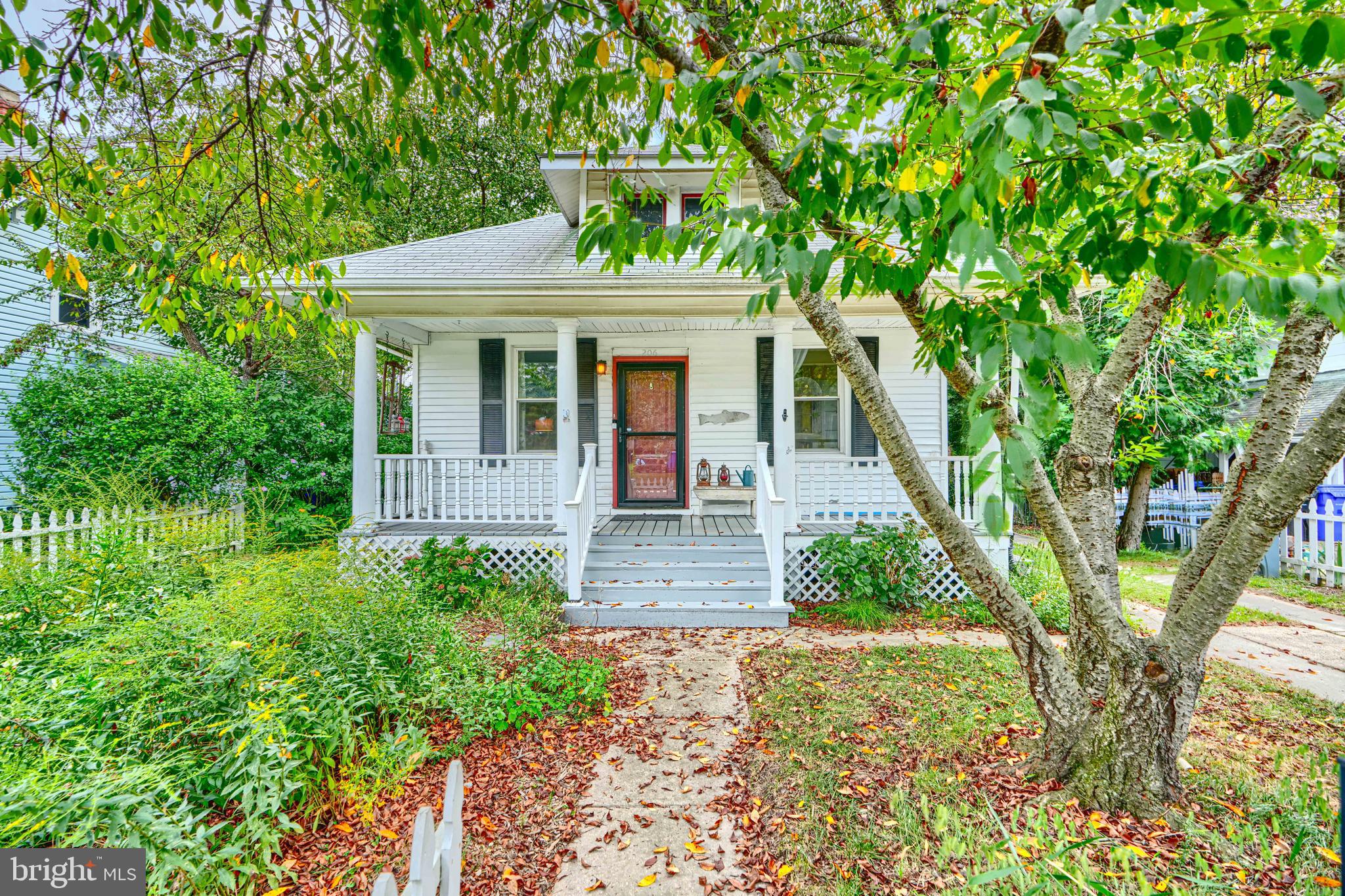 Don’t miss out on this extremely charming cottage style home just a block away from historic Main Street in Laurel! Located on a quiet tree-lined street, this adorable home is framed with a picket fence and an extremely inviting front porch where you can sit back and relax your day away. A beautifully designed 120 square foot rain garden enhances the front yard. Featuring a plethora of pollinator friendly native plants, this rain garden naturally manages stormwater, reduces runoff, and attracts butterflies and songbirds—offering both an eco-friendly function and vibrant curb appeal. The interior includes hardwood floors throughout, historic features including built-ins from the 1920s, and modern features mixed in throughout the home. The kitchen was completely gutted and rehabbed just 3 years ago, and boasts vaulted ceilings and a lovely breakfast nook or office with a wood burning stove. Storage compartment located above primary bedroom, finished with a loft-style beam adding just the right touch of charm. The primary and secondary bedrooms are placed perfectly around the main bathroom, featuring a classic clawfoot tub and updated vanity. The basement is huge and perfect for storage and a workshop space. The back deck was replaced in the fall of 2024, overlooking a private backyard and vegetable garden. Relax on your back deck after picking fresh delicious figs from your own giant fig tree. Exterior sewer line recently replaced in 2024. Enjoy low energy bills thanks to the solar panel roof! Huge driveway with ample parking and an EV power dock. Just blocks away from the Marc train station and minutes from major highways. Don’t let this gem slip away, schedule your private showing today!