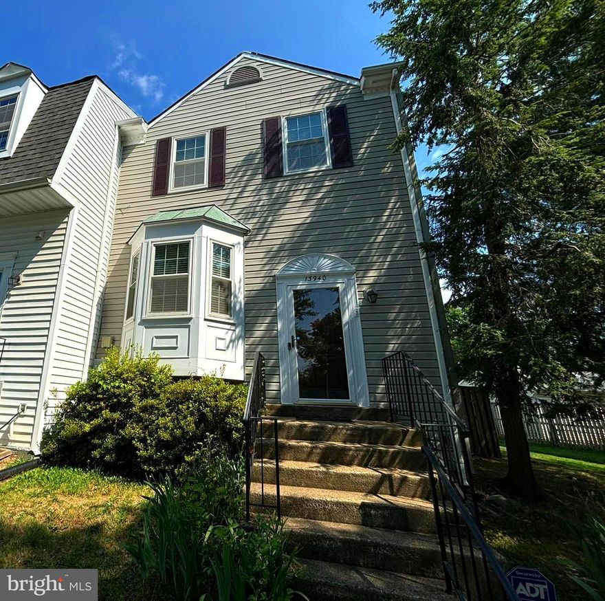 This elegant end-unit townhome in the desirable Singletons Grove Community offers 4 bedrooms and 3.5 bathrooms across three levels. The main floor features an open floor plan with hardwood floors in the living and dining areas, and luxury vinyl plank (LVP) flooring in the kitchen. The kitchen is equipped with upgraded appliances, granite countertops, and a cozy eat-in area. The upper level includes a spacious primary bedroom with a vaulted ceiling and an upgraded en-suite bathroom, along with two additional bedrooms and a full bathroom. The lower level boasts a charming wood fireplace, the fourth bedroom, a full bathroom, and a laundry room.   Detached two-car garage and space to park 2 more cars  in driveway,  which is a desired amenity.   The rear  fenced yard between garage and house add for privacy.   This home combines modern upgrades with comfortable living spaces, perfect for families seeking a vibrant community.