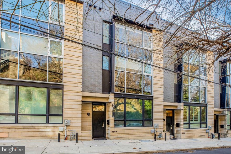 Luxury nearly new construction in the heart of Manayunk- 4586 Silverwood is a stunning townhome that offers ample spaces to enjoy everyday living and easy entertaining. Designed with 11 ft tall ceilings and at 20 ft wide, this home will impress any buyer that walks in. A five stop elevator is the ultimate in convenience. Pull into your two car garage, and enter into a flex space in the lower level- perfect for an office, workout room, or playroom. The chef’s kitchen is an entertainer’s dream, featuring Thermador and Sub Zero appliances, carrera marble counters, and modern flat panel cabinetry. The living room is spacious yet cozy, with a linear gas fireplace and open shelving. La cantina doors lead out onto the patio that features a retractable awning. The primary suite spans the entire third level, featuring two walk-in closets, a very spacious primary bathroom with dual vanities, luxurious soaking tub, two water closets, and a Juliet balcony. The fourth floor has three additional bedrooms and two full bathrooms. The top floor has a second sub zero beverage refrigerator, and access to the rooftop deck with jacuzzi. The roof deck is landscaped with a low maintenance succulent garden that regrows each year. Stunning views from atop the hill are yet another highlight. This home is perfect for the buyer who wants the ultimate in luxury, urban living, and easy access to the suburbs and main line. Bonus- 6 years left on the tax abatement!
