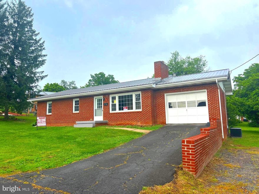 REDUCED to under appraised value! Nicely maintained brick rancher on large corner lot. New metal roof and heat pump recently installed. Wood fireplace that is perfect for insert. Kitchen cabinets have been painted and nice newer appliances allow you to have turnkey occupancy. Full, walk-out basement has plenty of space to finish to your liking. Hardwood floors in this very sound rancher! Plenty of space for vegetable and flower gardening!