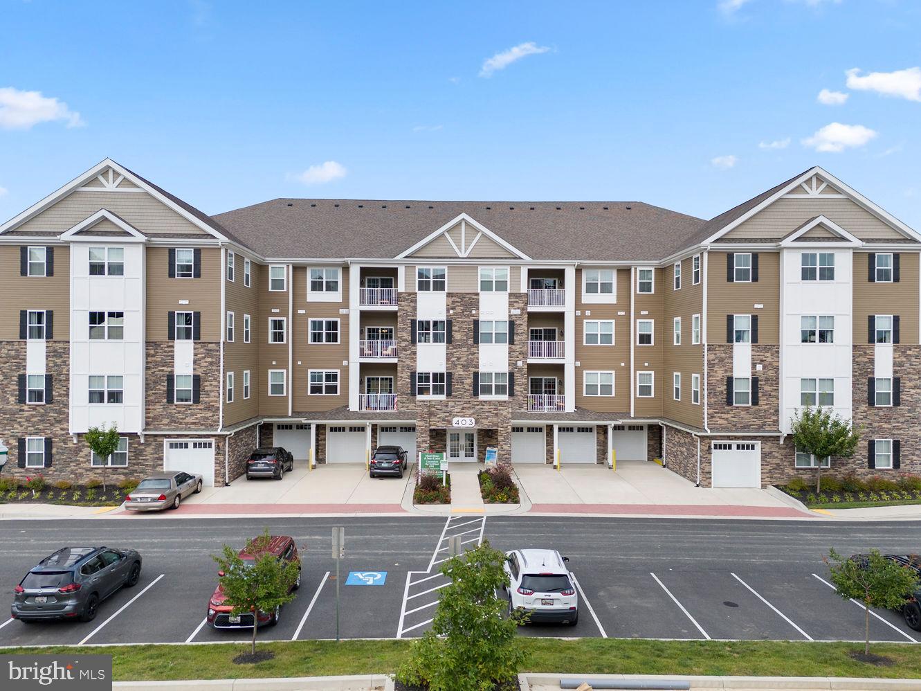 This 4th-floor penthouse condo in the sought-after Bulle Rock community offers 2 bedrooms, 2.5 baths, and 1,400 sq. ft. of thoughtfully designed single-level living in the Bel Air floorplan. The open layout connects a beautifully updated kitchen with quartz countertops, stainless steel appliances, a breakfast bar, and pantry to a spacious dining area and living room with an electric fireplace and a door leading to a private balcony overlooking the courtyard. The primary suite also provides balcony access through a sliding glass door and features a walk-in closet and a private bath with dual vanities, ceramic tile, and a stall shower. The second bedroom suite offers its own walk-in closet and full bath, providing flexibility for guests or family. A half bath and laundry area add everyday convenience. Additional highlights include an attached one-car garage and a separate storage unit. Residents enjoy low-maintenance living with services such as lawn care, snow removal, trash pickup, exterior building maintenance, and gated security included. Residents of Bulle Rock enjoy access to an impressive 37,000 sq. ft. clubhouse offering endless ways to relax and stay active, including indoor and outdoor pools, a fully equipped fitness center, tennis and pickleball courts, bocce, shuffleboard, scenic walking and biking trails, a library, and a cyber café. Conveniently located near I-95, the community provides easy access to Baltimore, Washington D.C., Wilmington, Philadelphia, and the MARC/Amtrak station, making travel simple and seamless. Here, comfort, convenience, and resort-style living come together in one remarkable setting.