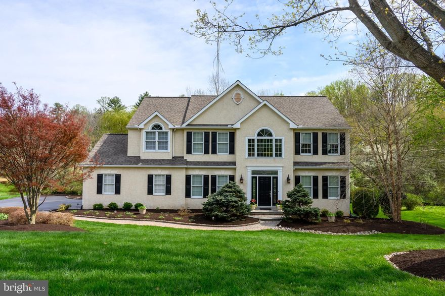 What a stunning property! Situated on a cul-de-sac street with a backdrop of mature trees, 202 Netherfield Ln offers a lovely sense of privacy. The 1.6 acre grounds will entice you outdoors, featuring a walking bridge over the John Smedley Run creek and into a beautiful woodland grove. The sophisticated 4 bedroom, 3.5 bathroom home takes full advantage of the views with a sweeping back deck with an electric awning, a back patio, and large windows at every turn. Jam packed with designer touches and architectural detail, you’ll enjoy a spacious floorplan with a grand foyer entry, dedicated home office, and formal as well as informal living and dining spaces, with transom windows and cut throughs to enhance the natural light and open feel throughout. Upstairs, the primary bedroom suite is an impressive space to get away from it all, with a walk-in closet, sitting room, a spa-inspired en suite bathroom with heated floor, and direct access onto a private back deck. What a retreat! There is also a hall bathroom on this floor, and each of the 3 hall bedrooms features a ceiling fan, nice closet storage and neutral carpeting. Downstairs, the finished walkout basement will quickly become your entertainment destination. With a built-in wet bar, full bathroom and walkout access to the back patio, you can enjoy seamless indoor/outdoor entertaining. There’s plenty of space to set up a home theater, game room, fitness room or more. Tucked in such an enticing location, you’ll still enjoy convenient access to nearby shops, dining, and commuter routes with a number of nature preserves including Stroud and Harmony Hill both 10 minutes away. Request a personal tour today!