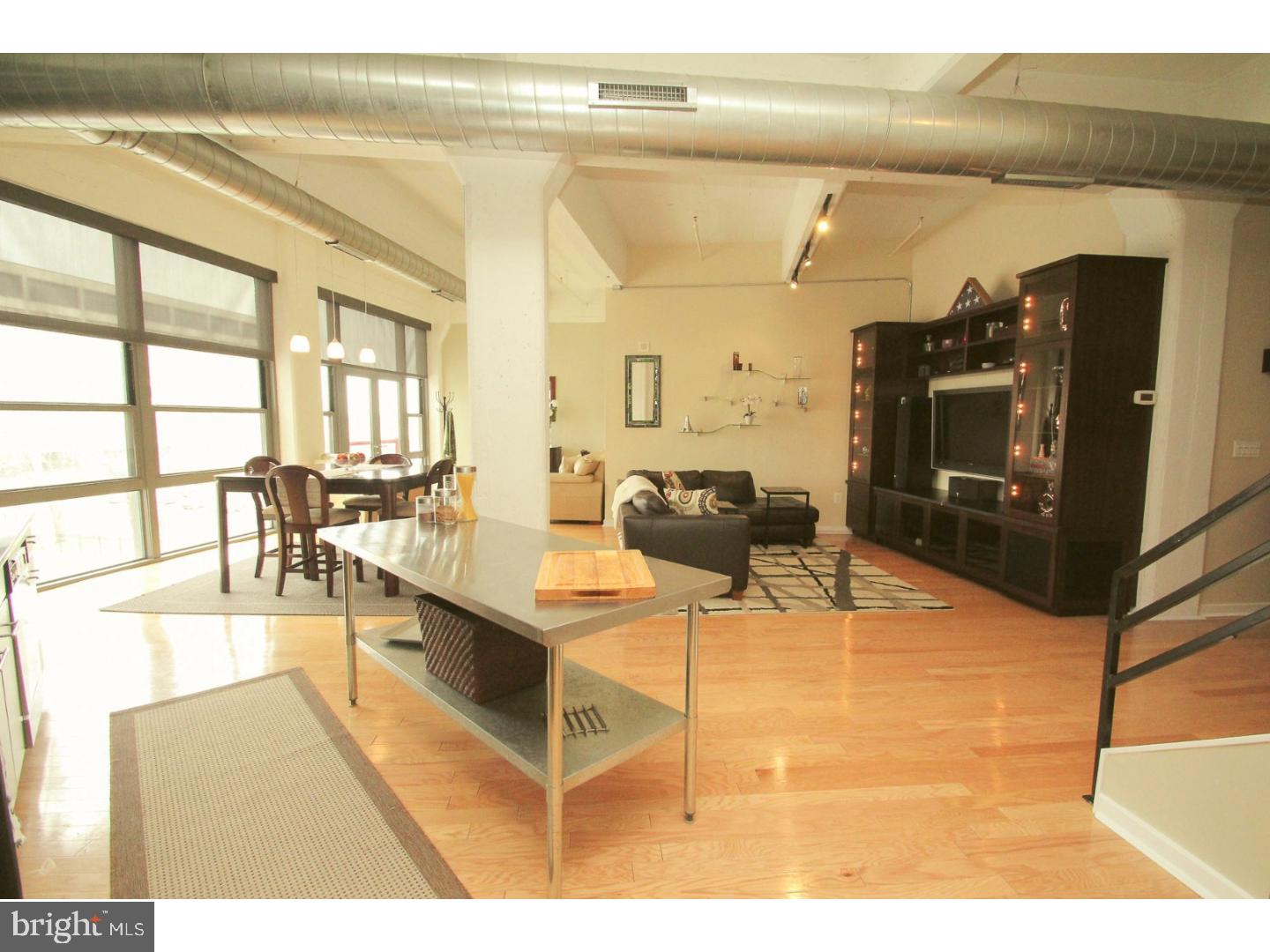 Welcome to this stylish loft style condo with deeded parking located between the desirable Northern Liberties and Old City neighborhoods of Philadelphia. This bi-level unit features upgrades throughout such as hardwood floors, bathroom tile/vanities, custom entertainment center, window treatments, and closet systems. This 2 bedroom 2 bath condo is one of the largest 2 bedroom units in the building and has a wide open floor plan that is an entertainer's dream. The tiled entryway leads you to the modern kitchen with granite counters, stainless appliances, glass tile backsplash, large island, and pantry cabinet. Next to the kitchen is a dining area and bonus sitting area, complete with Juliet balcony, floor to ceiling windows bringing in a ton of natural light, and custom window blinds. The living room area is also off the kitchen and includes a custom built entertainment unit made of wood, soapstone, and glass. The master bedroom has three closets with custom systems and an en suite bathroom with stall shower and glass enclosure. The second bedroom is also a great size and includes two large closets. There is an additional full guest bathroom, a laundry area with newer washer/dryer, and even more closets! As if there wasn't enough storage within the home, there is an additional storage unit in the building. One car deeded parking in the gated parking lot is included in the price of the home. The sellers also rent a parking space in an adjacent lot which is available to the new owner if desired. This pet friendly building includes 24/7 front desk concierge service/security, a fully equipped fitness center, convenient store, restaurant, and on-site maintenance. Steps away from all of the shopping, restaurants, galleries, and history of Old City/Northern Liberties combined with easy access to I-95, bridges, and 76? the location can't be beat! Make your appointment today to see this beautiful home, you will not be disappointed.