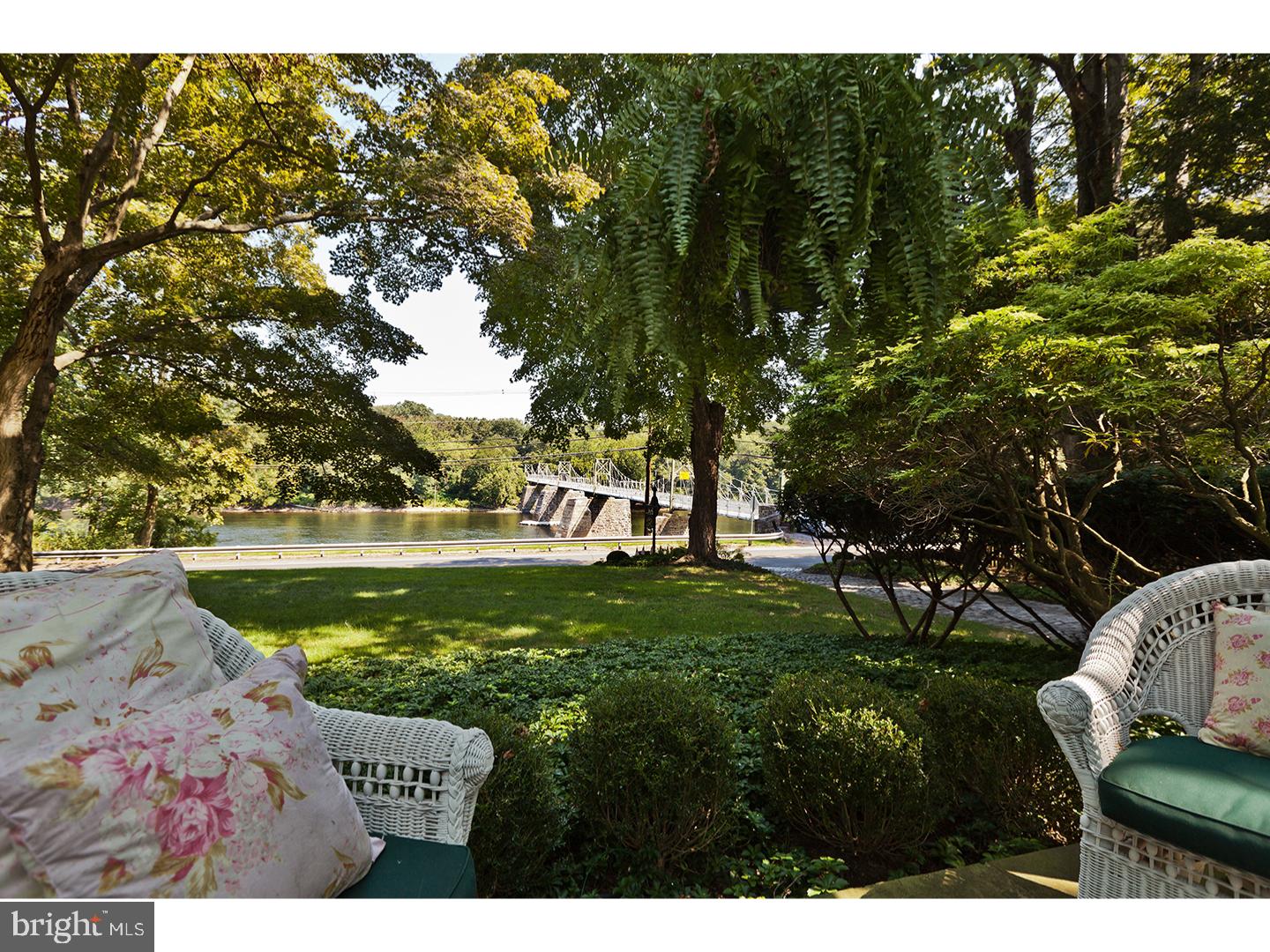 Porch furniture included. With a classic front porch overlooking the Delaware River & footbridge to Bull's Island, Bridgeview House conveys quiet dignity. Inside, its original manor house details & proportions have been beautifully preserved, & direct water views are visible from all 3 floors. Substantial original Federal Greek Revival-style trim & millwork, oversized sash windows, 10+ foot ceilings & gorgeous wood floors throughout the house. Both the formal LR & DR each have their original FP surrounds, & the DR includes built-in china storage. Big country kitchen UPDATED w/new appliances, quartz countertops. center island, plus wood floor; pantry, back stairs; dramatic great room w/stone FP & French doors opening to a delightful pool & rear yard. Front & back stairs to BRs, including a main suite w/sitting room/office; 3 additional BRs. 3.1 baths. 3rd floor includes en suite BR, dressing room & a trunk room. Picturesque carriage house/garage, small barn with office, stairway to storage loft. In an incomparable historical village setting; walk to Black Bass Hotel for fine dining or a tavern menu, or the Lumberville Store for breakfast, lunch or dinner. Enjoy boating activities on the Delaware River, and walk, run, or bike on the Delaware towpath plus nearby country roads are perfect for a stroll or running, Walk across the road to the Lumberville walking bridge on a moonlit night, you will experience the magic of living in this uncommon River Village. Owner is licensed PA Realtor.