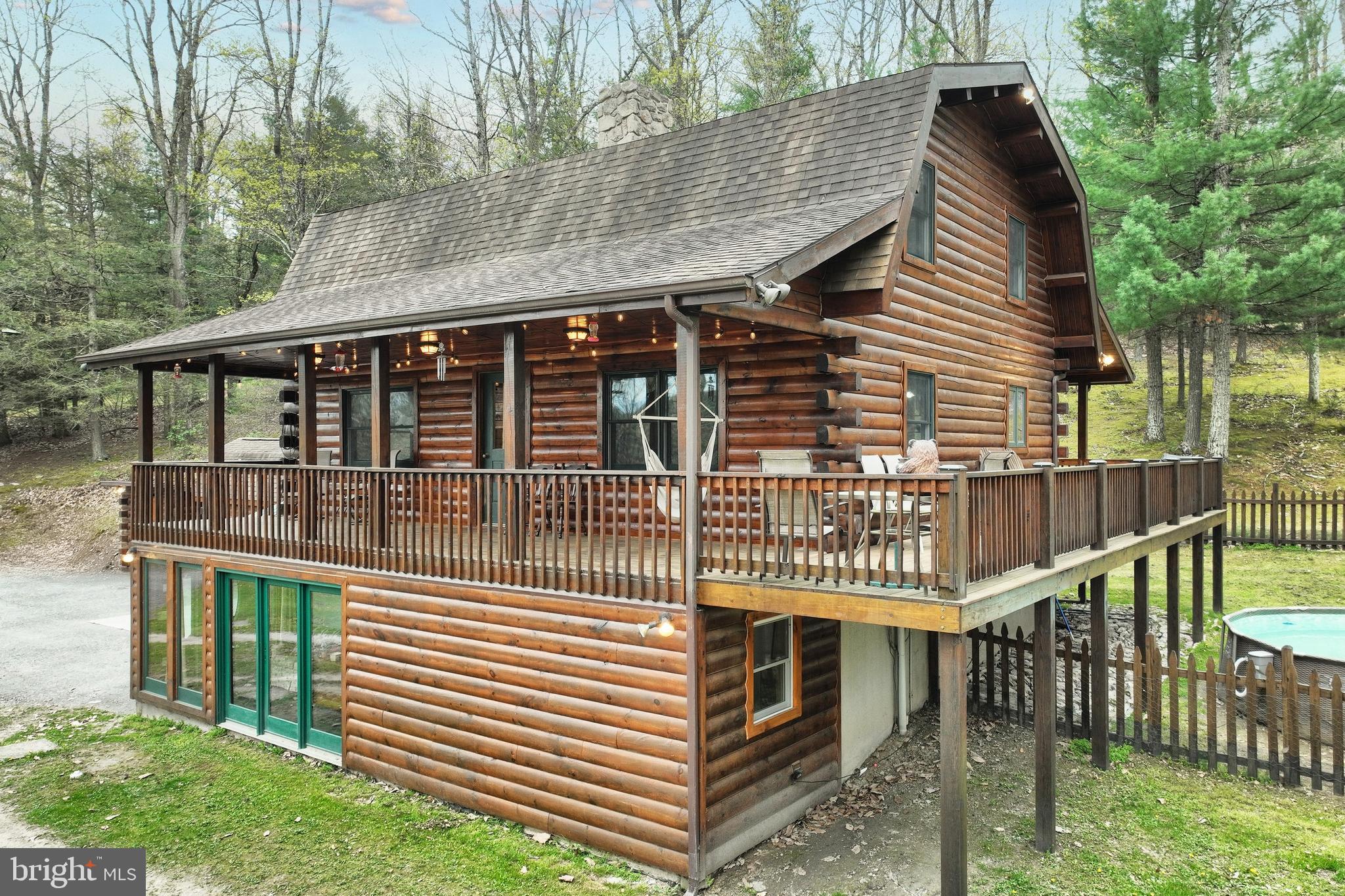 Fantastic location bordering State Game Lands. Undeniably striking custom log home featuring a beautiful post and beam design with vaulted ceilings, gleaming wood floors, abundant natural light, breakfast nook, and wrap around deck with front/rear covered porches. Additional heat sources include a coal stove or wood burning fireplace. The basement offers flexibility for guest quarters, home office, gaming or comfortable additional living space. Basement was formed with superior walls. Outside you will find an adorable custom built cottage that perfectly matches the home, fire pit, picnic area, garden areas, above ground swimming pool and walking trails.
Truly unique living experience!