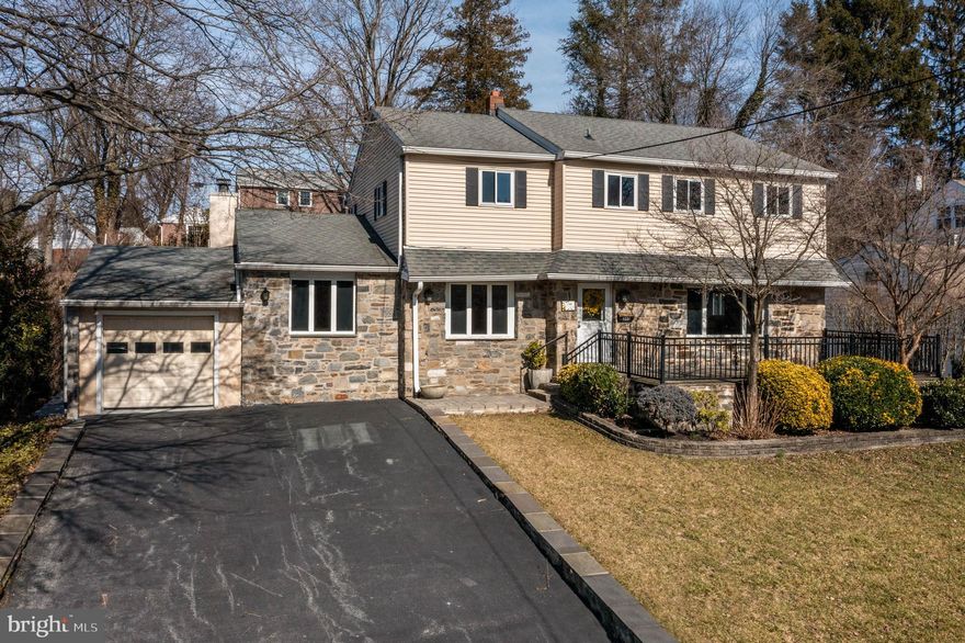 A large and inviting front patio welcomes you to 240 David Drive, a surprisingly spacious colonial in the sought-after Paddock Farms neighborhood in Havertown. With southern exposure, this home is flooded with natural light throughout the day. The expanded family room, large, eat-in kitchen with breakfast room, and well-proportioned living and dining rooms offer space to grow and enjoy this home for years to come. The stunning family room has a cozy wood-burning fireplace, with plenty of space for a sectional sofa and big screen TV, and even a billiards or ping pong table if that is your style! The kitchen has abundant cabinet and counter space,  a double-oven and gas range, so invite your family and friends and enjoy cooking and entertaining!  There is even a convenient main floor laundry / mudroom with back door access to the yard and garage. Hardwood floors extend throughout the main living level and second floor, including all bedrooms. On the second floor, the king-sized primary suite has two closets, and an attached full primary bath with a double-sink vanity. Also on the second floor are three more bedrooms.  Two of the three other bedrooms are quite large  (measuring over 16'x 12'), and can easily accommodate two twin beds with desks and dressers - and possibly even two larger full or queen beds, depending on your needs.  Also on this floor is a hall bath with a tub-shower combination. Outside, there is an attached one car garage (no inside access, but access to the back yard and easy access to the mudroom/ laundry entry). The back yard has a lovely covered patio (accessible from the breakfast room), some flat grassy yard space, and terraced garden beds. Plant herbs and vegetables, perennials or evergreens for year round color - or a combination to keep your kitchen well-stocked with fresh produce, and your home brightened with fresh cuttings throughout the year.  The (rough finished) basement offers plenty of extra storage and houses the HVAC and utilities.  Could this be your "forever" home?  Visit one of our open houses or make an appointment today!