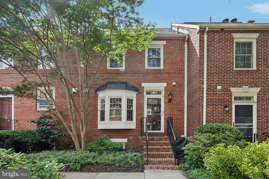 Live the best of Old Town Alexandria in this beautifully updated and spacious 3-level townhouse, ideally located just a half-mile from King Street Metro and steps from charming brick-lined streets filled with boutiques, cafes, and fine dining. Nestled in a peaceful, well-kept community, this inviting home features warm hardwood floors throughout and a stylish kitchen with gleaming granite countertops, stainless steel appliances, a farmhouse sink, custom tilework, and chic lighting. The main level offers a bright, open layout perfect for entertaining, with space for a dining table, a custom bar with wine fridge, and a welcoming living room complete with built-ins and a cozy wood-burning fireplace—plus a convenient half bath for guests. Upstairs, two generously sized bedrooms each boast two closets and share a beautifully renovated hall bath with a luxurious jetted tub and separate glass-enclosed shower, with access from the primary bedroom. The lower level provides even more living space with a full bath, a family room lined with built-ins, and a flexible den ideal for a home office or guest room. Step outside to your private, fully fenced patio—perfect for morning coffee or evening gatherings. Around the corner, you’re just minutes from award-winning dining, boutique shops, and the buzz of King Street. Spend weekends soaking in the historic charm of Old Town, biking or jogging along the scenic Mount Vernon Trail, or strolling to local parks. Two reserved parking spaces are available, and there is extra storage in the attic. This is Old Town living at its finest!