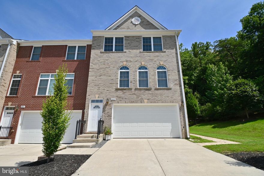 Beautifully maintained brick-front end unit townhome overlooking mature trees with numerous upgrades. Open and inviting floor plan with gleaming hardwood floors on main and upper levels, high ceilings, crown molding, and plenty of recessed lighting. The gourmet kitchen boasts stainless steel appliances, granite countertops, and a breakfast area with an adjoining family room that leads out to the beautiful deck. The large primary bedroom features a walk-in closet, upgraded master bath, granite dual vanity, custom tile, spa soaking tub, and separate shower. The walk-out lower level offers a recreation room with tile flooring and sliding doors leading to the brick patio.   Conveniently located just minutes to Ft. Belvoir, 95/395/495, 2 metros, Springfield Town Center, and walking distance to Wegmans and multiple restaurants.