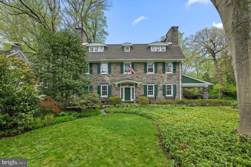 Tucked away in northside Ardmore, is an elegant 3 story stone Colonial on a beautifully acre (+/-) manicured lot.  Built in Circa 1900, this home offers old world charm with today’s modern amenities, walk to the Ardmore Train Station, Suburban Square, restaurants and shops.  Wow!!
Gracious Entry Foyer welcomes you, a grand staircase, gleaming hardwood floors, detailed moldings, deep windowsills and French doors throughout the main level.  Formal Living Room with gas marble fireplace, and outside exit to covered patio perfect for entertaining.  Formal dining room with marble fireplace, gourmet eat-in kitchen, soapstone counters, stainless steel appliances including a Miele dishwasher, double oven, Sub Zero Refrigerator, double sinks, center island seating for four, Viking gas cook top w/griddle and Dacor fan, microwave, island sink, recessed lighting, pantry closet, plus cabinets galore.  Back staircase to the second floor landing and additional staircase to the basement!  Kitchen opens into a skylit breakfast room and great room with floor to ceiling windows, built-ins, entrance to slate patio, Office with custom built-ins and desk, second den features screened in porch, mudroom, 1st floor laundry w/Bosch washer and dryer plus Powder Room.   OE to driveway, detached 2 car garage and parking for 6+.  
2nd Floor offers spacious owners’ suite w/fireplace, spa-like bath w/soaking tub, walk-in shower, double sinks & vanity.  Dreamy screened in porch, dressing room with custom built-ins and closets.  Two additional large bedrooms with fireplaces, linen closet and hall bath complete the 2nd floor.
3rd Floor provides a 4th bedroom with custom window seats, ensuite Bath with clawfoot tub, 5th bedroom currently being used as an office with pocket doors to a bonus room, possible 6th bedroom or sitting area, walk-in cedar closet, and Hall Bath.
Freshly painted basement includes second laundry area w/washer and dryer, plus a fabulous temperature-controlled Wine Cellar with 1300 – 1400 bottle capacity, built-in wooden racks, center marble-topped bar with additional storage.
Additional amenities feature new house roof in 2019, exterior freshly painted 2022, 3 Zone Heating and cooling, Rachio Wi-Fi smart lawn sprinkler controller (panel) for the entire property, whole house Gas Generator, Motion-Detector LED Lighting surrounding home and garage, Ring Doorbell System for front door and driveway, Electric Entry Security Gate, Alarm System and much, much, more!