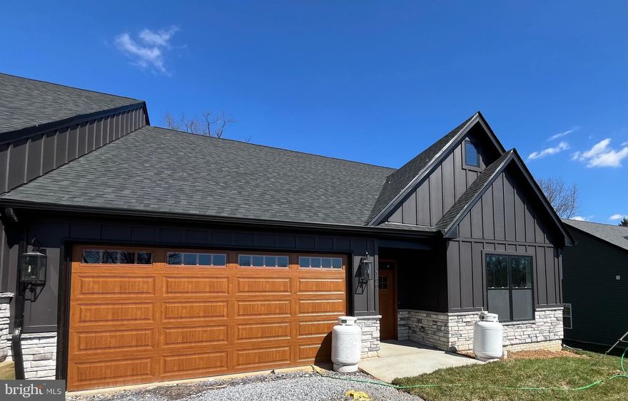 BRAND NEW, FINISHED, and READY TO BE YOURS!  First-floor, low-maintenance living just minutes from the downtown area of Shepherdstown!  Love where you live and enjoy a short stroll or bike ride to town, new library, Morgan's Grove Park, local schools, Shepherd University, and all the quaint shops and eateries.   This 4 bedroom, 3 bath villa floor plan offers first-floor living accented by impeccable finishes.  High ceilings, luxury vinyl floors, quartz countertops, stainless appliances, and an incredible flow throughout!  The open kitchen floorplan connects the living room and the eat-in kitchen, which is highlighted with a nicely sized kitchen island, farm sink, black stainless upgraded KitchenAid appliances set for refrigerator, dishwasher, stove and double oven.  The living room offers nine-foot ceilings and a gas fireplace with designer brick work and access to the rear covered, screen porch that's perfect for outdoor serenity or entertaining.  There is a conveniently located laundry room located just off the primary bedroom.   The spacious primary bedroom suite offers a walk-in closet, cathedral ceilings, brick accent wall and adjoins the primary bathroom.  The primary bath is tiled and has a double vanity and a spacious, glass-enclosed shower.  Continuing on the main level, there is a second and third bathroom both complemented by ample closet space and a full bathroom with tub and shower.   Upstairs, you will find a finished fourth bedroom with its own closet and a full bathroom with tub and shower.  A two-car garage completes this newly built villa.  Book your showing today while these villas last!