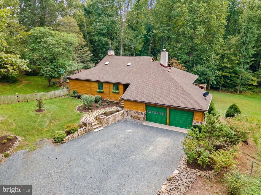 Contemporary style log home on 11+ acres.  The main level has an open floor plan with a big, beautiful great room, cathedral ceiling, wall of windows overlooking back yard, master suite and updated kitchen.  The upper level has 2 additional bedrooms, full bath and several nooks and crannies offering numerous possibilities.  Expansive deck spans the entire length of house.  Brand new roof, freshly painted throughout and ready for you to call "home"!