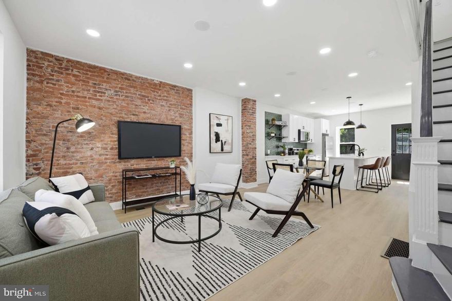 DESIGNER RENOVATION IN WEST PHILLY | EXPOSED BRICK | 10 YEAR TAX ABATEMENT! Welcome to 5856 Angora Terrace, a masterfully reimagined 3BR/1BA row home on a premier, quiet block. This turnkey residence features high-end designer finishes and modern efficiency throughout. MAIN LEVEL: Open-concept living defined by a signature exposed brick wall and integrated in-ceiling speakers. The gourmet kitchen is a showstopper, boasting a quartz island, designer green-tile backsplash, and brand-new stainless steel appliances. BED & BATH: The upper level offers three sun-filled bedrooms and a spa-inspired bath with custom black hexagonal tiling and a high-tech lighted vanity mirror. BONUS SPACE & EFFICIENCY: High-Efficiency Living: Fully updated with a brand-new HVAC system and heat pump for low utility costs. The Basement: A clean, well-illuminated, high-ceilinged walk-out basement with direct access to the backyard—perfect for a gym or storage. Outdoor Oasis: Enjoy an oversized backyard, a rare city find perfect for hosting and gardening. LOCATION: Perfectly situated steps from Cobbs Creek Park and the Baltimore Ave trolley line for a direct commute to University City (UPenn/CHOP) and Center City. Highest-quality renovation in 19143—don't miss out!