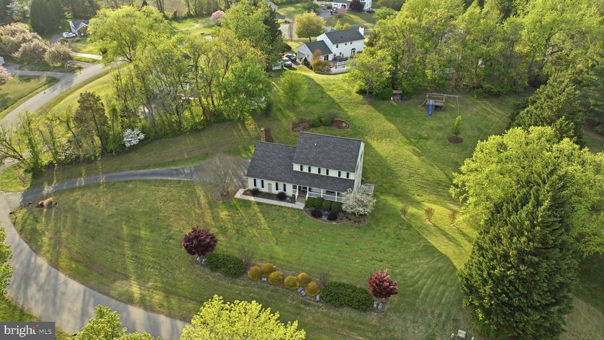 STUNNING AND SERENE IN OWINGS! Perched in a gorgeous setting in Owings, this beautifully maintained 4-bedroom, 3.5-bath Colonial sits on a private 1-acre setting that offers both space and a sense of escape.

From the moment you arrive, the inviting front porch and updated front door create a warm, welcoming first impression. Inside, the main level truly stands out, with refinished natural oak floors flowing throughout and a layout that feels both open and intentional—perfect for everyday living and effortless entertaining.
The kitchen has been thoughtfully updated with stunning fantasy brown granite countertops, stainless steel appliances, and newer cabinetry, blending style and function in all the right ways. Just off the kitchen, the living space is anchored by a wood stove set against a beautifully whitewashed brick backdrop, adding character, warmth, and a cozy focal point. A well appointed half bath adds to the updated style of this floor.

Upstairs, you’ll find three comfortable bedrooms, including a primary suite with its own private bath which is completely renovated, creating a peaceful retreat at the end of the day. An updated hall bathroom and bedroom level laundry room complete the upstairs.

The finished basement expands the home’s versatility, offering a rec area with built-ins, a wet bar for entertaining, and a private den/bedroom that works perfectly as an office, hobby room, or guest space, along with a full bath and additional storage.

Out back, the tiered yard creates a natural, usable landscape that feels both private and inviting, while the gravel patio area is ideal for relaxing evenings or gathering with friends.

Blending thoughtful updates, timeless character, and a beautiful setting, this home delivers the kind of lifestyle that’s hard to find and easy to fall in love with.

***New Windows being Installed in the Coming weeks!***

Schedule your private tour today; this won't last long.