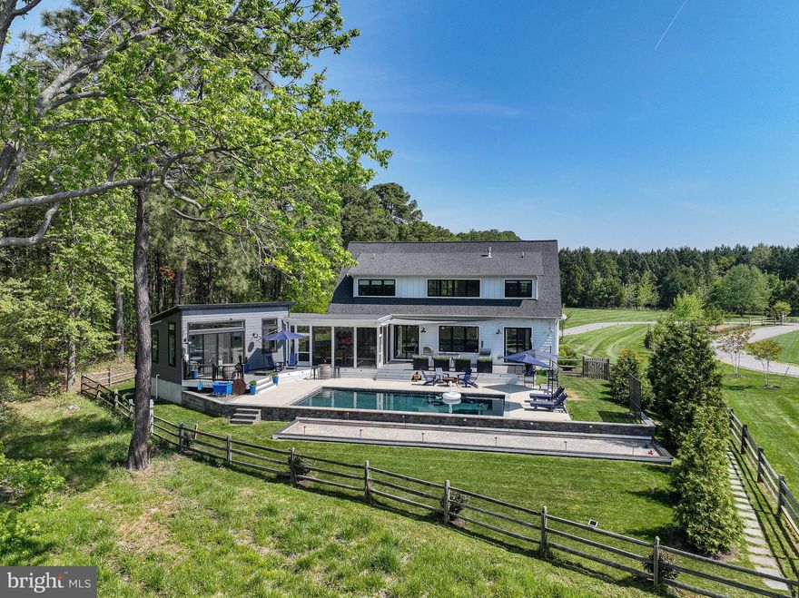 Fabulous in-town St. Michaels waterfront property – This coastal style waterfront residence, built in 2020, offers approximately 3,000 square feet of thoughtfully designed, sophisticated yet relaxed waterfront living space on San Domingo Creek. Located within town limits, the property enjoys direct access to the St. Michaels Nature Trail, allowing effortless walkability to shops, dining, and cultural amenities—no car required.
Designed for both comfort and entertaining, the light filled interior features an open floor plan with high ceilings, a well-appointed chef’s kitchen, and a welcoming fireplace. Four private bedroom suites – including a primary suite on the main level - make it a breeze to accommodate larger family gatherings and visiting friends. A spacious screened waterside porch, heated inground pool, deck and Bocce Court extend the living space to the outdoors for seasonal entertaining and warmer weather fun.
A separate pool house/studio, connected by the screened porch and breezeway, includes a full bath and offers flexibility for use as a home office, creative space or additional guest quarters.
The 2.3 acres lot is located at the edge of the San Domingo Cove community and is adjacent to protected woodlands, providing privacy, and offers with public water and sewer and a fully fenced backyard. Boating enthusiasts will appreciate the dock (shared with one neighboring property), offering two dedicated slips and a floating dock per owner and water depths of approximately 4–4.5 feet at the slips and 3 feet at the floating dock. From here it is easy to boat to Tilghman Island and Oxford, and San Domingo Creek is also great for kayaking and canoeing. 
An exceptional and rare opportunity to enjoy refined, in town waterfront living in one of Talbot County’s most sought after communities.