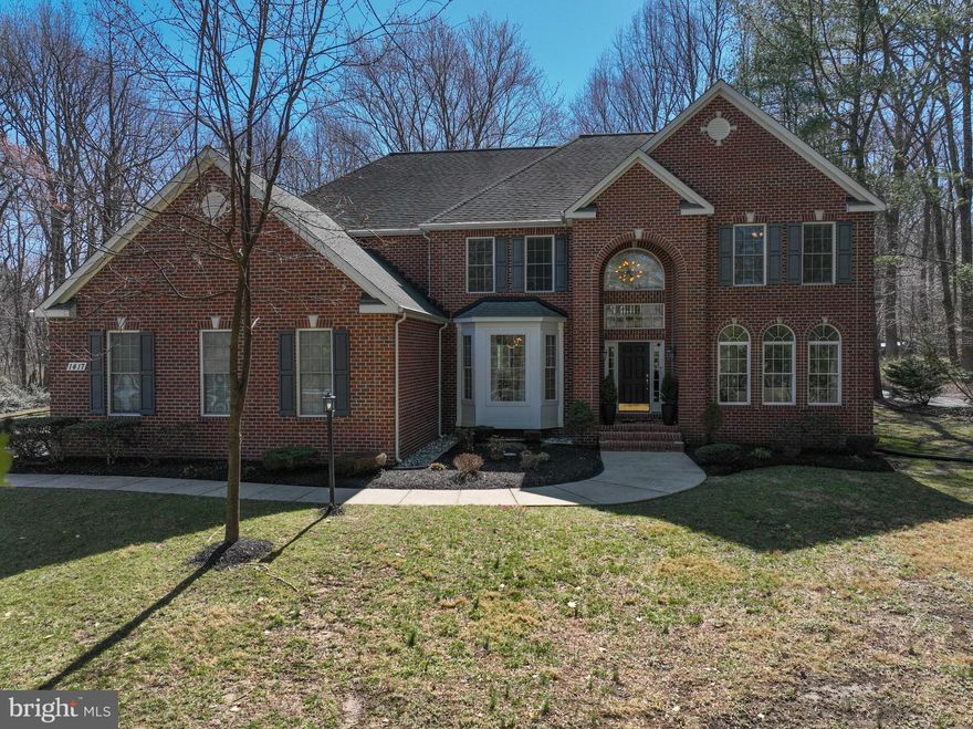 Welcome to this meticulously maintained, custom built colonial home situated on a spacious 1.25-acre private lot with no HOA. As you step inside, you're greeted by the warmth of the hardwood floors, natural light throughout and an inviting open floorplan, perfect for modern living and entertaining. 
The gourmet kitchen in this home boasts granite countertops, stainless steel appliances, New dishwasher and cooktop (2024) and plenty of storage and counter space. Adjacent to the kitchen is the stunning two-story family room, screened in porch and separate breakfast area. A formal dining room and living room is located at the front of the house along with a self-playing grand piano ( conveys with house), perfect for those family gatherings and holidays.  This home also offers a first-floor bedroom adjacent to the family room with a full bath, perfect location for an in-law suite or Au pair. Double staircases bring you to the second floor where there is three additional bedrooms with NEW carpet and a beautiful primary suite with tray ceilings. The spa like primary bath was remodeled in 202O with a luxurious soaking tub and oversized garden shower with rain towers.The basement of this house is an entertainment dream with a theatre room which includes a Bose stereo system, 65" TV  and theatre chairs and pool table that all convey with the home.  The basement also features a full bath, office space, kitchenette and plenty of storage.  This backyard of this property has endless possibilities.  
Step outside to the patio and enjoy the serenity of the expansive lot, offering plenty of space for outdoor activities and relaxation. 
Easy commute to Washington DC, Baltimore, Annapolis and BWI. Don't miss the opportunity to make this beautiful colonial your new home. 
Home Warranty included.