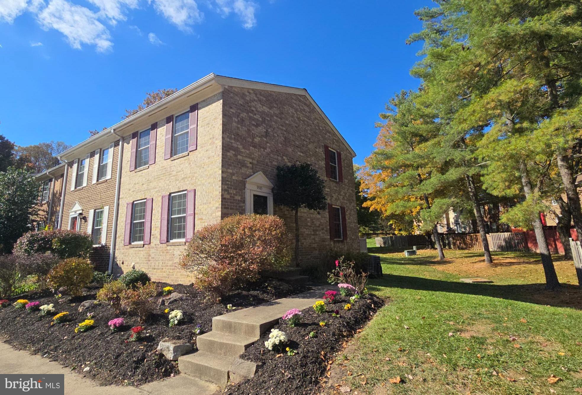 This all-brick, end unit townhome features substantial updates throughout. A private side entrance overlooks green space with attractive landscaping, and leads into the updated kitchen, highlighted by contemporary wood cabinetry with gleaming granite counters, designer tile backsplash, and replaced appliances including new oven (2023), dishwasher (2023), and garbage disposal (2024). The living room is light-filled due to extra end unit windows, and a replaced slider door. The slider leads to the replaced composite deck, and overlooks the rear yard and open space. The upper level features three spacious bedrooms and an updated full bath with granite vanity and upgraded ceramic tile flooring. The lower level provides a laundry area, abundant storage, and space for customization. With an assigned parking space and just steps to the neighborhood center, pool, and walking trails, and only minutes to shopping, restaurants, and commuter routes, this location could not be more convenient. All this, and a brand NEW Roof w/ 50 year architectural shingles (2025) and a replaced HVAC (2017). Move-in ready and all the big items have been completed!