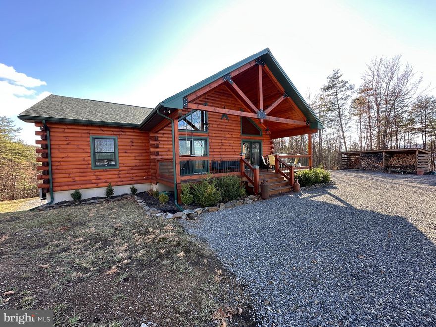 HERE FOR A GOOD TIME.....PRISTINE LOG HOME WITH ALL THE EXTRAS ON 37 USABLE WOODED ACRES......MASSIVE LONG RANGE AND LAYERED MOUNTAIN VIEWS TO THE NORTH, MIDDLE OF NOWHERE PRIVACY, YET LESS THAN A MILE OFF THE PAVED ROAD & ONLY 2 MILES FROM DOWNTOWN ROMNEY. THIS HOME WAS BUILT WITH FAMILY & FUN AT THE FOREFRONT.....5 BEDROOMS FOR PLENTY OF GUESTS, LAMINATE FLOORS THOUGHOUT FOR EASY CLEAN UP, PICNIC PAVILLION, ATV TRAIL AROUND THE PERIMETER, 200 YARD SERIOUS SHOOTING RANGE AND PLENTY OF TOY STORAGE....8X20 SEA CONTAINER WITH ELECTRIC AND 12X27 QUONSET HUT FOR THE BIGGER TOYS. READY FOR FUN ON DAY ONE....CONVEYS TURNKEY & FULLY FURNISHED.....COMPLETE WITH SHUFFLEBOARD, POOL TABLE & PINBALL MACHINE! HUNT, SHOOT, ATV'S, MULTIPLE PUBLIC RIVER ACCESS POINTS WITHIN A FEW MILES.....TONS OF OUTDOOR ACTIVITIES AT YOUR FINGERTIPS. LOCATED IN "THE WOODLANDS" A SMALLER GATED COMMUNITY OF LARGE LOTS ON THE OUTSKIRTS OF TOWN. IT'S NEXT TO IMPOSSIBLE TO FIND THIS TYPE OF PROPERTY IN SUCH A CONVENIENT, YET TOTALLY PRIVATE LOCATION.....SIMILAR PROPERTIES ARE TYPICALLY 4-10 MILES BACK WINDY DUSTY ROADS AND 20+ MINUTES FROM BREAD & MILK....NOT THIS ONE! THE LAND IS NICE TOO....GREAT MIX OF PINES & HARDWOODS, TRAILS, EASY TO HIKE & HUNT. MAKE IT YOUR ULTIMATE WEEKEND COMPOUND OR FULL TIME SPREAD.....ONLY 2 HOURS WEST OF THE DC BELTWAY BUT FEELS LIKE YOU'RE ON THE OTHER SIDE OF THE GLOBE! WHETHER YOU'RE HERE FOR A LONG TIME OR JUST HERE FOR A GOOD TIME, THIS ONE'S A WINNER!