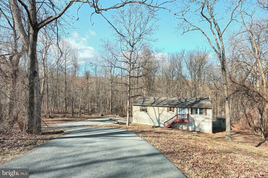 Nestled on a scenic hillside in the picturesque Carroll Valley, this charming property offers a peaceful retreat with 1,800 square feet of well maintained living space. Boasting recent upgrades and thoughtful improvements, it’s equipped with a Home Energy Monitoring System and an EV Charging Station, making it a modern, eco-friendly choice.

Enjoy the serenity of the area while being just minutes from Route 15, with easy access to both Maryland and Gettysburg. This unique property spans nearly 2 acres, spread across four separately deeded lots, offering endless opportunities for privacy, expansion, or investment.

For added security and peace of mind, the property features a remote-controlled security gate, with additional surveillance equipment. 

The main level of the home includes 3 spacious bedrooms, 2 full bathrooms, a well-appointed kitchen, a comfortable living room, and a walk-out deck perfect for relaxing. The lower level offers flexibility with a bedroom/office, storage room, laundry room, game room, and a 2-car garage complete with EV charging capabilities.

Whether you’re looking for a peaceful getaway or a new place to call home, this property combines comfort, space, and a prime location in one of the region’s most desirable areas. Included in the sale are an Emporia J1772 Level 2 EV Charger and an Emporia Home Energy Monitoring System for added convenience.