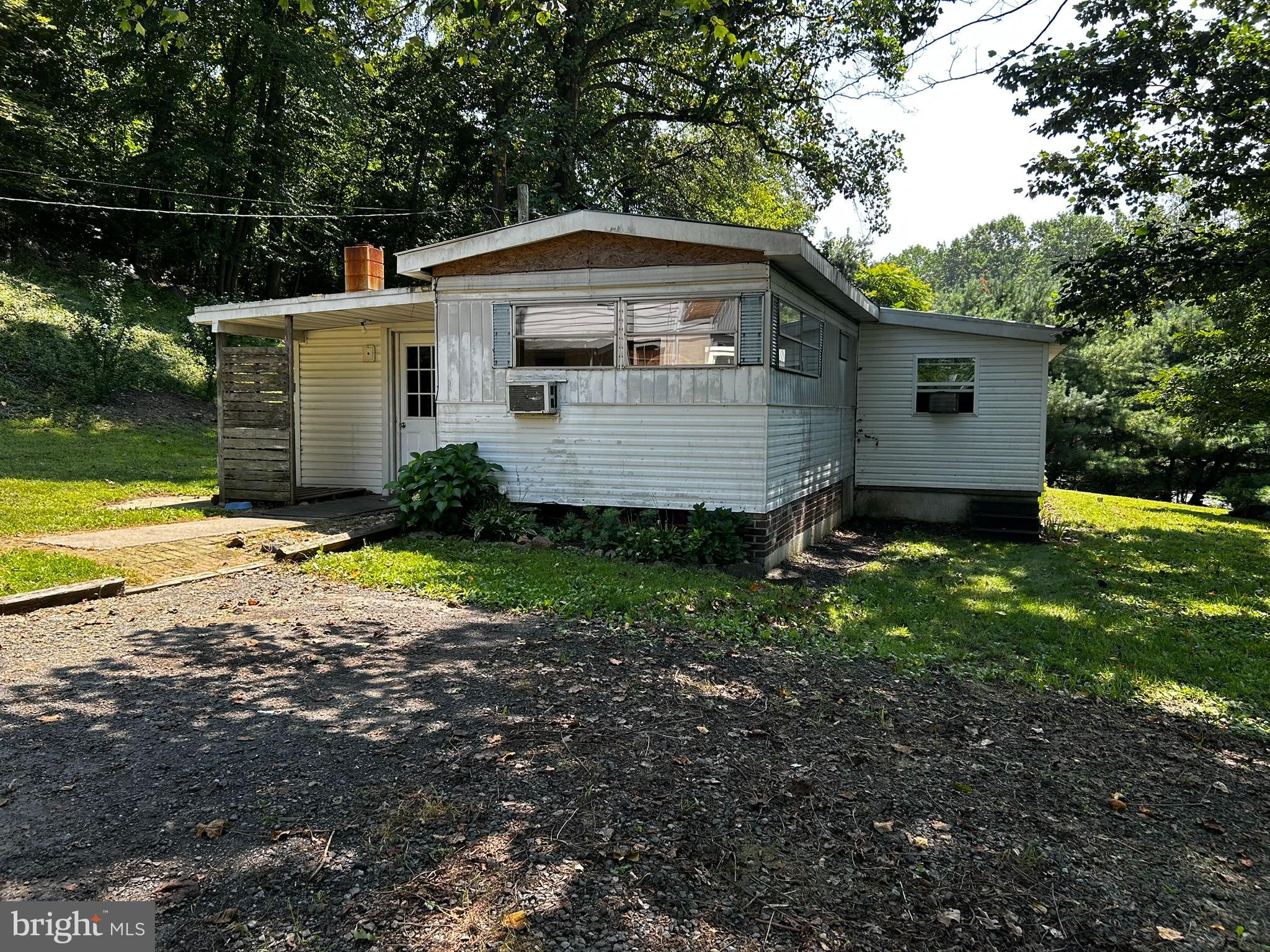 Welcome to this cozy and rustic home on a secluded wooded setting! Enjoy the peace and quiet of the rural location, with the convenience of all the shops, restaurants and entertainment of nearby Reading, PA. The outside features mature shade trees, a large driveway with extra parking, and a detached 2 car oversized garage with electric and a second story. Inside you will enjoy the quaint and cozy feel of the home, with a wood burning stove for extra warmth and comfort in the chilly months. The addition on the home lends to a large dining area and living room for relaxing or entertaining. Come check out this home today!