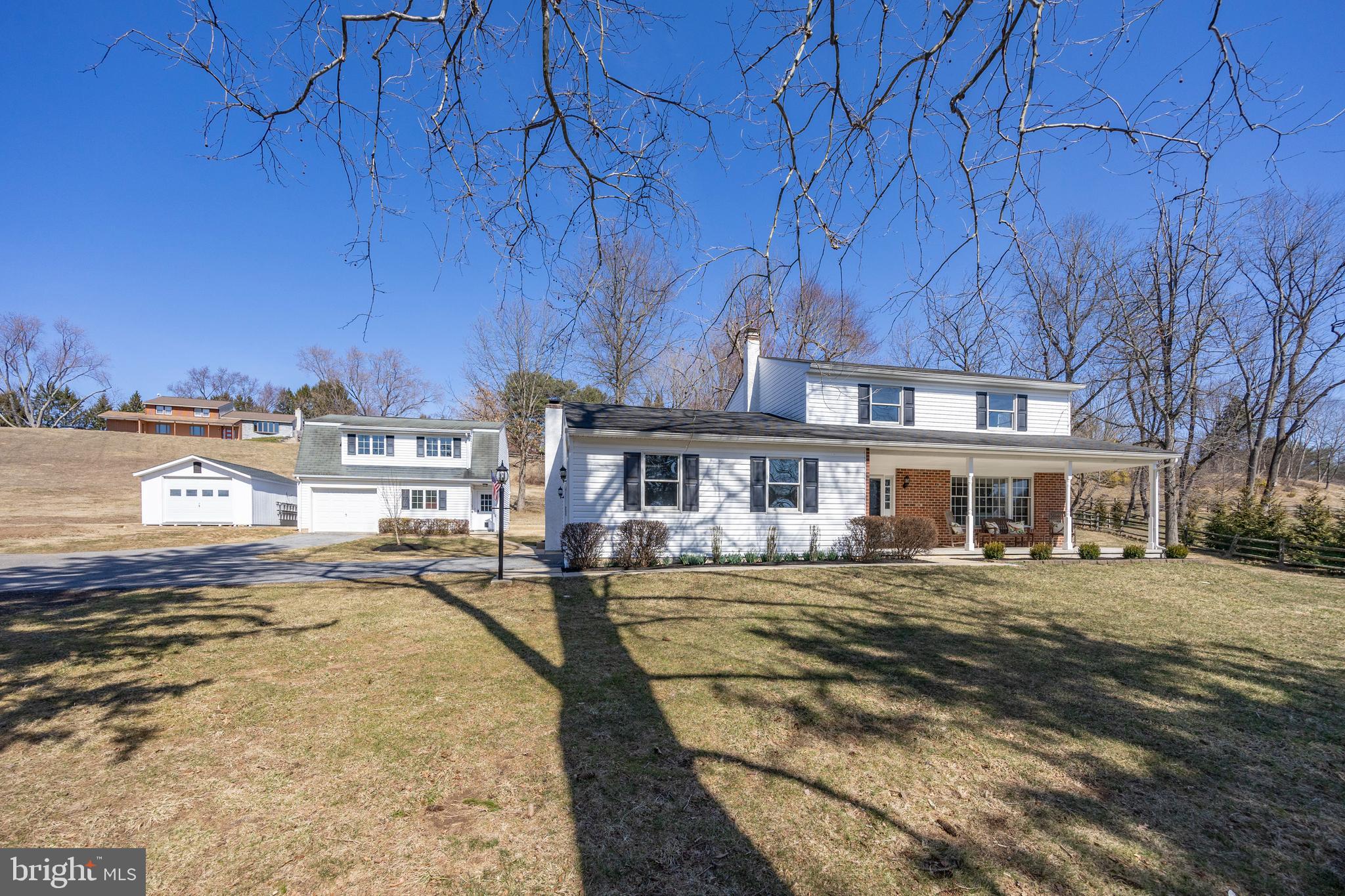 Set on a private 1-acre lot, this beautifully updated 4-bedroom, 2.5-bath home with attached 2 car garage in West Chester offers 2242 sf of living space, modern upgrades, low taxes, and incredible versatility. A 28’ x 24’ outbuilding with high ceilings serves as a spacious workshop, perfect for woodworking, furniture refinishing, or recreational and work vehicle storage, while a separate entrance with staircase leads to a finished room above, ideal for a home office, art studio, or gym. A newer shed provides extra storage, and an extended driveway accommodates 5+ vehicles. A spacious covered front porch welcomes you into the freshly painted interior, where new wood floors extend throughout most of the first level. The comfortable floor plan includes a living room with built-in shelving and a bay window, a dining room for entertaining, and an eat-in kitchen featuring KraftMaid cherry cabinetry, new stainless-steel appliances, granite countertops, and a tile backsplash. The cozy family room boasts a brick fireplace and ceiling fan, while the 20 x 16 sunroom, with new LVP flooring and a wall of windows overlooking the private backyard, offers the perfect flex space for a playroom, office, home gym or entertaining guests. A laundry room and remodeled powder room complete the first floor. Upstairs, the primary bedroom includes a brand-new bathroom, while three additional bedrooms share a fully renovated hall bath. The basement, featuring two egress windows and studded walls, is ready to be finished for additional living space. Recent updates include a new heating and air conditioning system – efficient heat pump with oil back-up heating system (2024), siding, gutters and garage door (2022), three renovated bathrooms (2024), garage door on the outbuilding (2025), new well pump and well cap (2024) and well pressure tank (2023), wood flooring (2025), carpeting on the second floor (2025), LVP flooring in the sunroom (2025), ductwork cleaning (2024), chimney liner, crown and stucco redone (2018), and updated lighting and hardware throughout. Located in the award-winning West Chester School District (Rustin HS, Stetson MS, and Westtown-Thornbury Elementary) with convenient access to Routes 202, 3, and 100, this exceptional property is just minutes from the fantastic dining and shoppes of West Chester Borough. Don’t miss this special opportunity—schedule your showing today!