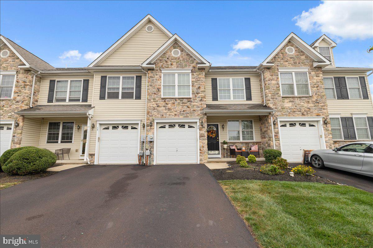 Welcome To 20 Ryan Court, A Move-In Ready Cultured Stone-Front And Vinyl Sided Beautifully Maintained 3 Bedroom, 3.5 Bath Townhome Nestled In The Desirable Ryan Court Community In Telford Borough, Montgomery County, PA; With 1,740 Square Feet Of Thoughtfully Designed Living Space, This Immaculate Gem Combines Comfort, Style And Modern Updates; Step Inside To Find Gleaming Pergo Floors in The Living Room & Dining Area And A Recently Painted Interior That Sets The Tone For A Bright And Welcoming Atmosphere; The Ultra Modern Eat-In Kitchen Is A Chef's Dream, Featuring Granite Countertops, Maple Cabinetry, Electric Stove, Dishwasher, Disposal (1 Year), Glass Mosaic Backsplash, Lazy Susan, Pantry, Breakfast Bar, Pergo Floors With Sliders To A Rear Trex Deck (New In June 2025)- Perfect For Both Every Day Living & Entertaining; The Spacious Family Room Is A Cozy Retreat With A Heater Rated Propane Gas Fireplace Framed In Sleek Black Granite Surround, Ideal For Relaxing Evenings; The Powder Room Completes The First Floor; Upstairs You Will Find Three Generously Sized Bedrooms, Including A Primary Suite With An Abundance of Closet Space And A Private Bath With Double Vanity Sinks, Tile Floor & Stall Shower As Well As A Full Hallway Bathroom; The Full Finished Basement Expands Your Living Options With A Convenient Bonus Room (Or A Kitchenette) With 3x5 Entrance Area, Mini Refrigerator, Stone Mosaic Backsplash, Granite Countertops, Custom Cabinets From Home Depot (10x8), Den (13x10), Office (10x10) And A Full Bathroom (8x5) With Stall Shower - Perfect For A Home Gym, Hobby Space - As Well As Two Unfinished Storage Areas (12x8 & 11x13) Included In This Basement Area; Outside Entrance With Bilco Door; Enjoy Outdoor Living On The New Trex Deck Installed In June 2025 Or Relax On The Charming Front Covered Porch (5x4.5) ; Additional Highlights Include A 1-Car Garage With Opener, Updated HVAC System (New In January 2025), Central Vacuum System And Low Maintenance Exterior Features; Located Just Minutes From Local Shops, Parks, Dining And Commuter Routes, This Home Offers The Perfect Blend Of Suburban Tranquility And Convenience; Don't Miss Your Chance To Own This Spacious, Stylish And Truly Move-In Ready Home In One Of Telford's Most Sought After Communities; Quick Settlement Possible; Show This One Last, You Will Not Be Disappointed.