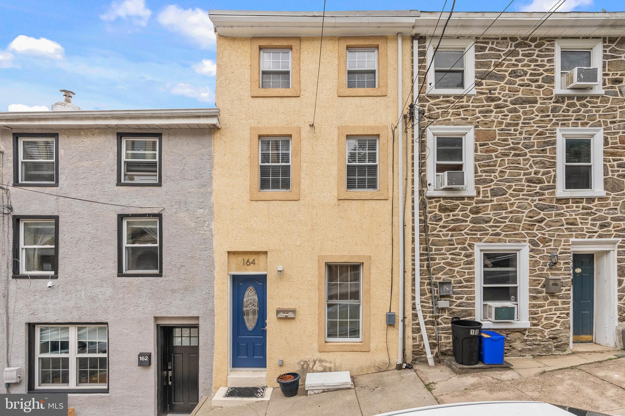 Nestled on a quiet block in Manayunk, just steps from lively Main St, you'll find 164 Grape St. This modern, 3-story home offers 3 bedrooms, 2.5 bathrooms, a finished basement, and a suburban-like backyard. A towering facade and vibrant blue door greet you out front. Inside, gleaming hardwood floors stretch across the open and airy main level, which has plenty of space for separate living and dining areas. At the rear is an updated kitchen featuring custom wood cabinetry, granite counters, a tile backsplash, stainless steel appliances, and a breakfast bar. The home's highlight is surely the huge backyard, where you can spend your summer days gardening, grilling, and hanging out with friends and family. More living space is found in the finished basement, perfect for a media room, home gym, or guests. A half bathroom and laundry room add functionality. Up on the second level, two carpeted, sunlit bedrooms and a large full bathroom sit off the hall. The third level is dedicated to the primary suite. There's an expansive bedroom, a double closet, and a second full bathroom. In addition to everything inside, 164 Grape St's fantastic location earns a Walk Score of 97! Nearby, Main St is a go-to destination for top-rated restaurants, local shops, lively entertainment, and community events. Extensive walking trails are close, plus Ridge Ave is lined with popular shopping centers a few blocks north. There's also easy access to I-76, Henry Ave, and Center City Philly via the Manayunk/Norristown Regional Rail. Schedule your tour today!
**If Buyer uses preferred lender, we are offering a Free 1% Rate Reduction for the first 12 months.**