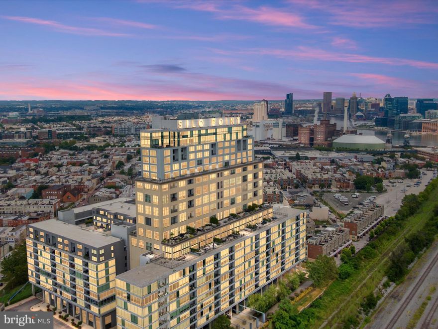 Welcome to the ultimate conversation starter, a Skytown at Silo Point that’s equal parts gallery, museum, sports hall of fame, and pop culture time capsule. Spread out over multiple levels, this 2-bedroom, 2.5-bath home with a den features high ceilings, large windows, and both an expansive terrace and a balcony, offering views that stretch from the northeast to the northwest.
Every inch of this place has something to say, and none of it whispers. Hallways double as a history walk, with framed front-page headlines marking moments that made you gasp, cheer, or shake your head. Movie posters stake their claim like Hollywood royalty, sports memorabilia flexes its championship cred, and collectibles spill from shelves in a glorious “I’ve been places, I’ve met people, and I kept the proof” kind of way. The powder room? A bold Orioles-orange love letter to baseball season. The den? Equal parts media shrine, game-day command center, and “just try not to get distracted” workspace.
When you’re ready to entertain, the gourmet kitchen is perfect for pre-party bites before spilling out to the terrace or balcony for skyline cocktails and mocktails. The primary suite is its own retreat, with private views, while the second bedroom is guest-ready (or display-ready, if you’re running out of wall space). New floors add a fresh polish, and two deeded parking spots make city living downright civilized.

Whether you keep the walls clean for your own treasures or follow the seller’s lead and turn them into conversation central, the home itself — not the memorabilia — is what conveys.

Residents of Silo Point enjoy 24-hour concierge services, secure access, a state-of-the-art fitness center with a yoga studio, a sky lounge on the 19th floor, pet-friendly areas, game rooms, and EV charging stations. On-site offerings also include Reflex Functional Fitness, InVein Aesthetics medical spa, and a bi-weekly farmers market hosted by Green’s Greens. Ideally located near Fort McHenry, major highways, BWI Airport, and all that Baltimore’s waterfront has to offer, this home provides elevated city living in one of the city’s most architecturally significant and amenity-rich buildings.