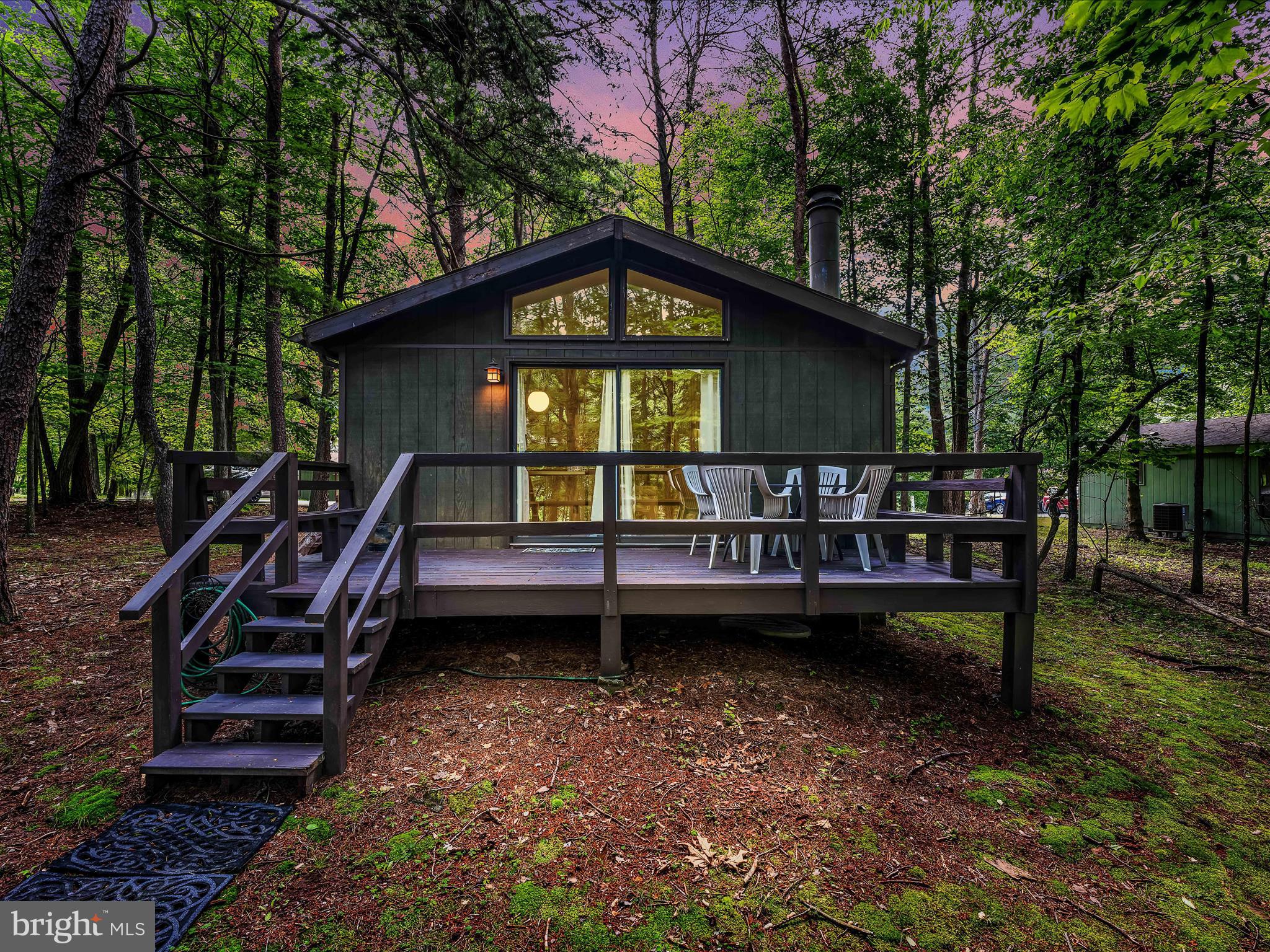 Very quaint cottage in the Woods Resort. Very bright inside with a fireplace and central heat and air for comfort. Large rear deck. Located within walking distance to the Woods Club for convenience. Can come fully furnished possibly. Everything is here to have a place to relax in. Very comfortable and just the right size to be able to take care of. Membership for the Woods Resort can be purchased.