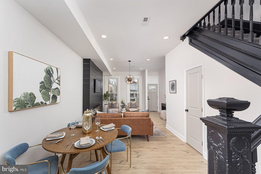 Welcome to an extraordinary masterpiece in the heart of the city with private 2 car parking. This newly renovated home offers 5 spacious bedrooms and 4.5 baths, including a luxurious owner’s suite. Additionally, there’s a welcoming first-floor bedroom suite that’s perfect for guests or multigenerational living. The main level features custom 8 foot tall windows that flood the interiors with natural light and 10 foot tall ceilings. LVP flooring and a shiplap covered fireplace serves as a one-of-a-kind centerpiece for entertaining in style. The gourmet chef’s kitchen boasts quartz countertops, 42” shaker cabinetry, a designer backsplash, and premium stainless steel appliances. Upstairs, retreat to spacious bedrooms, a convenient laundry room, and a show-stopping primary suite with a walk in closet and double bowl vanity. Designer lighting, luxe tilework, and upgraded fixtures elevate every detail throughout the home. Perfectly situated near major commuter routes and convenient access to downtown Baltimore, this home combines modern sophistication, timeless style, and everyday comfort.